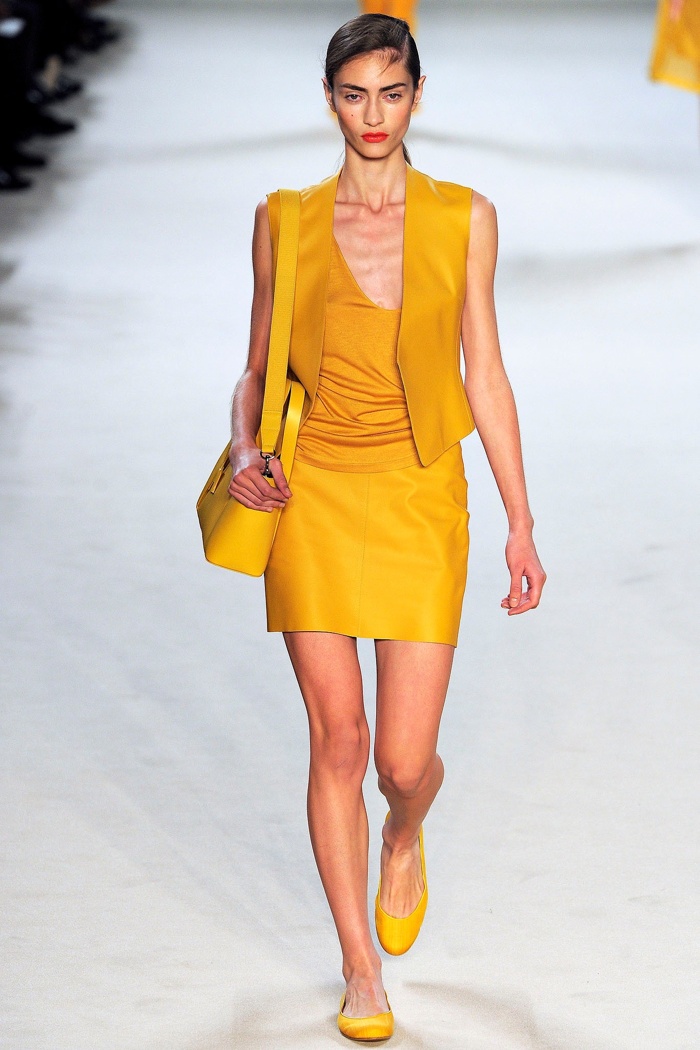yellow leather fitted vest and skirt