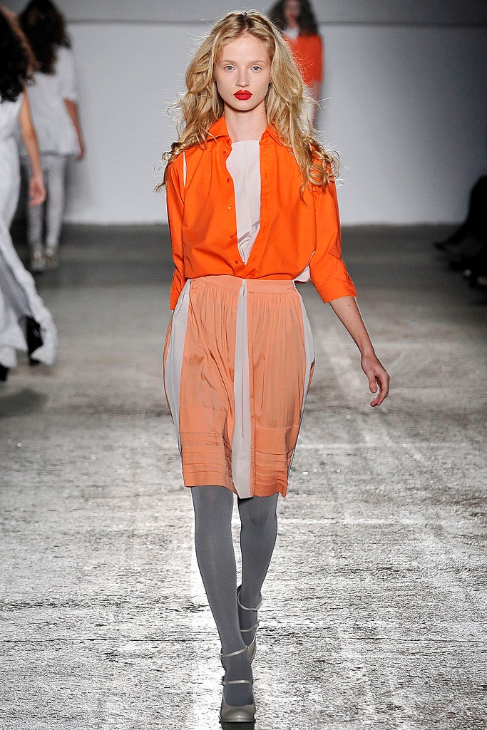 orange shirt and pleated skirt