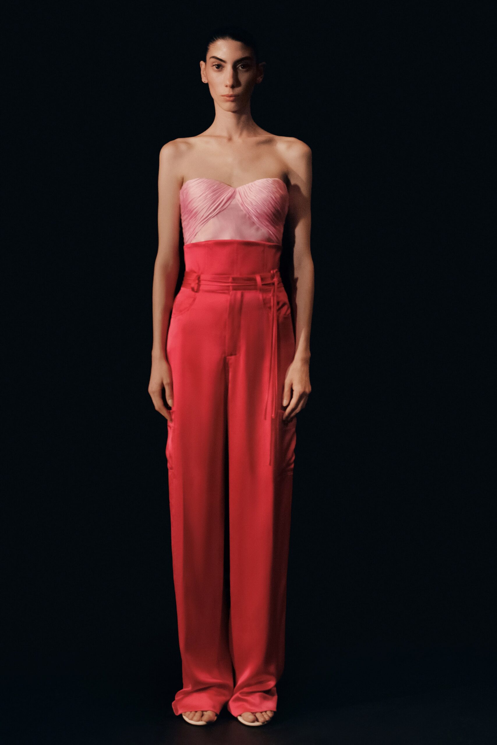 pink ruched strapless top with red tailored pants