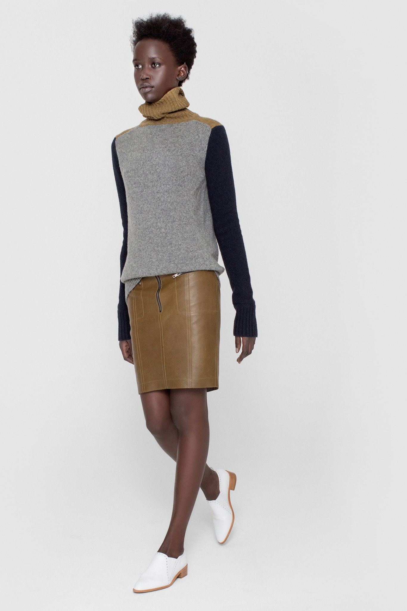 fitted gray wool sweater and brown leather skirt