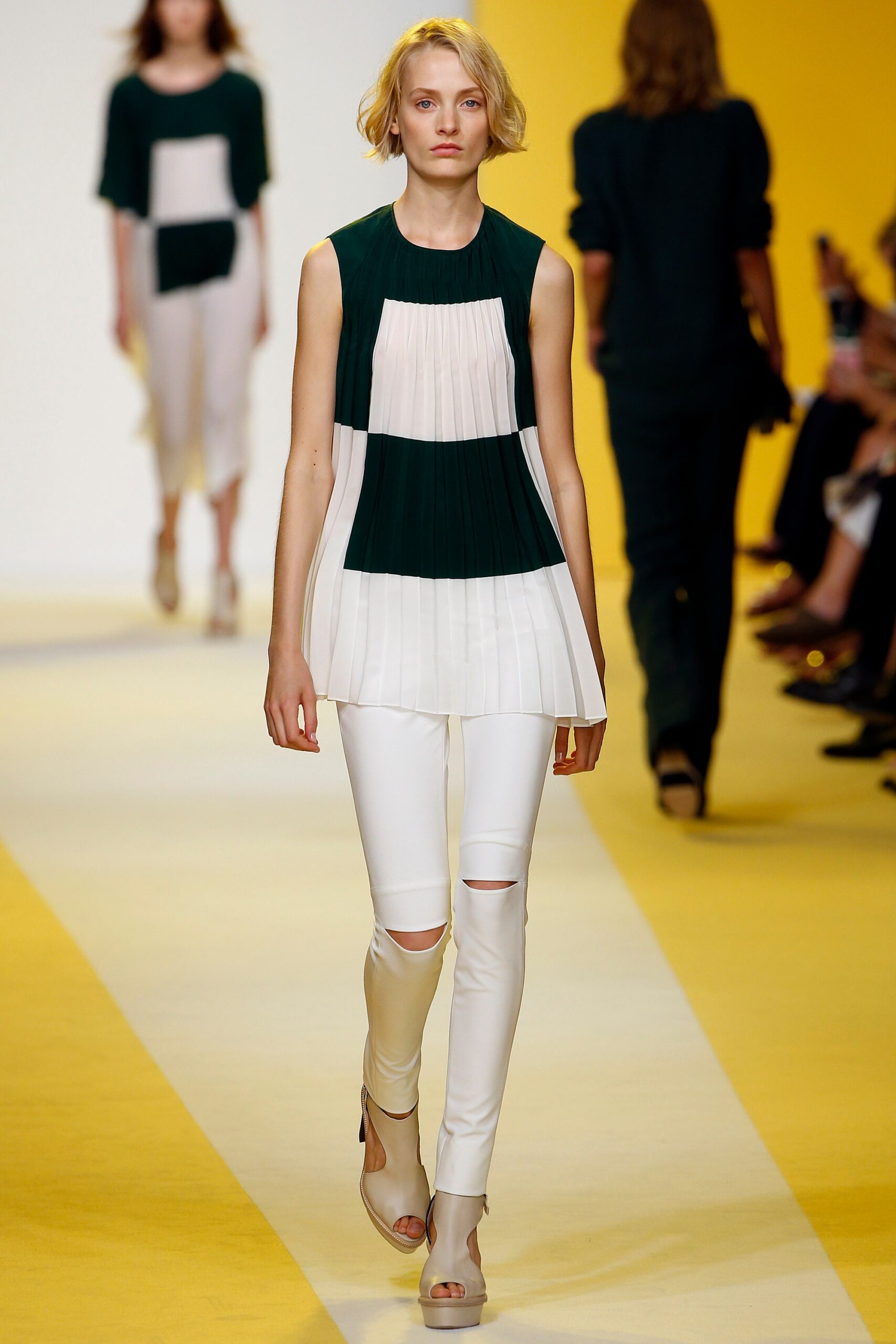 green and white pleated top with white pants