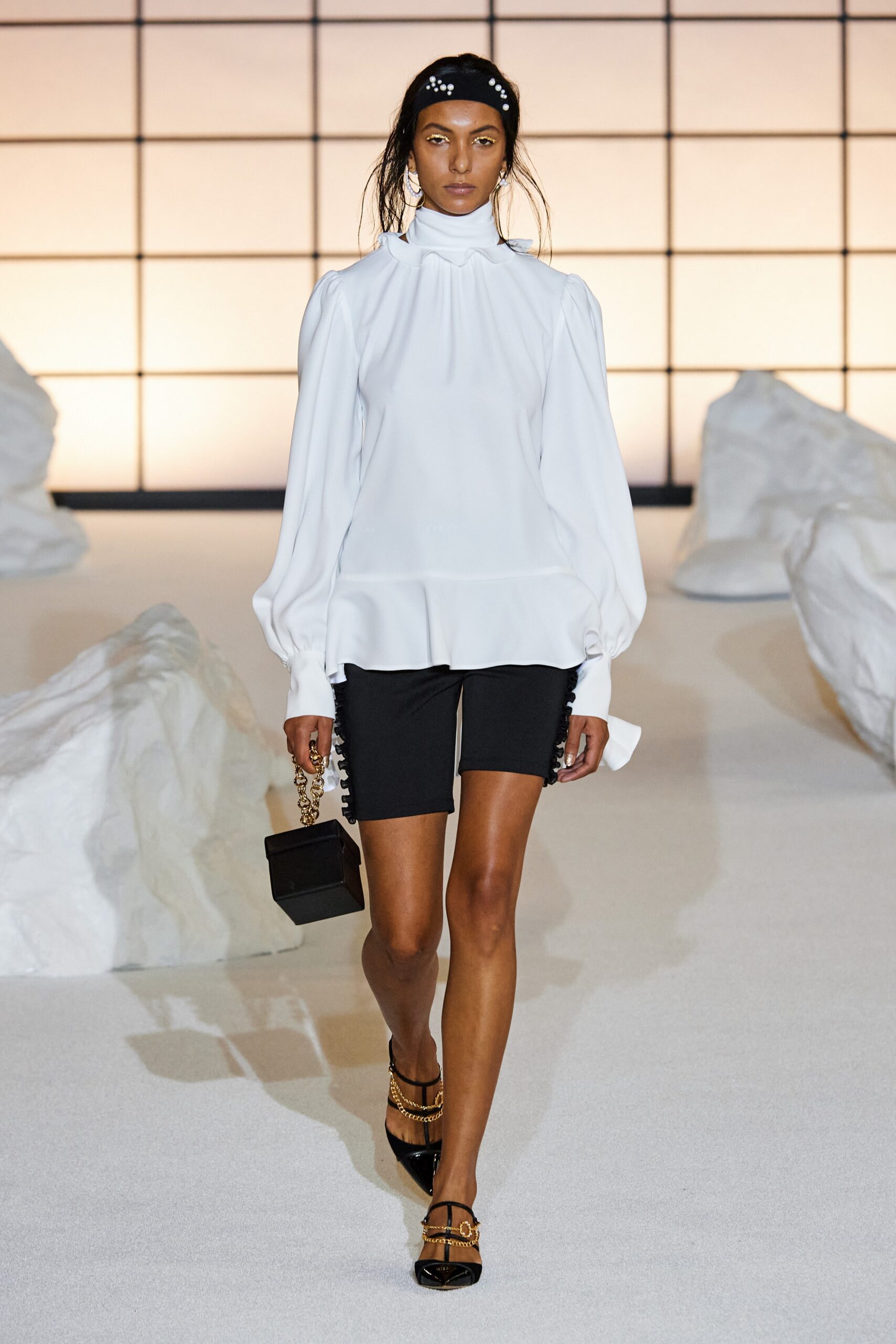 white silk blouse and black shorts