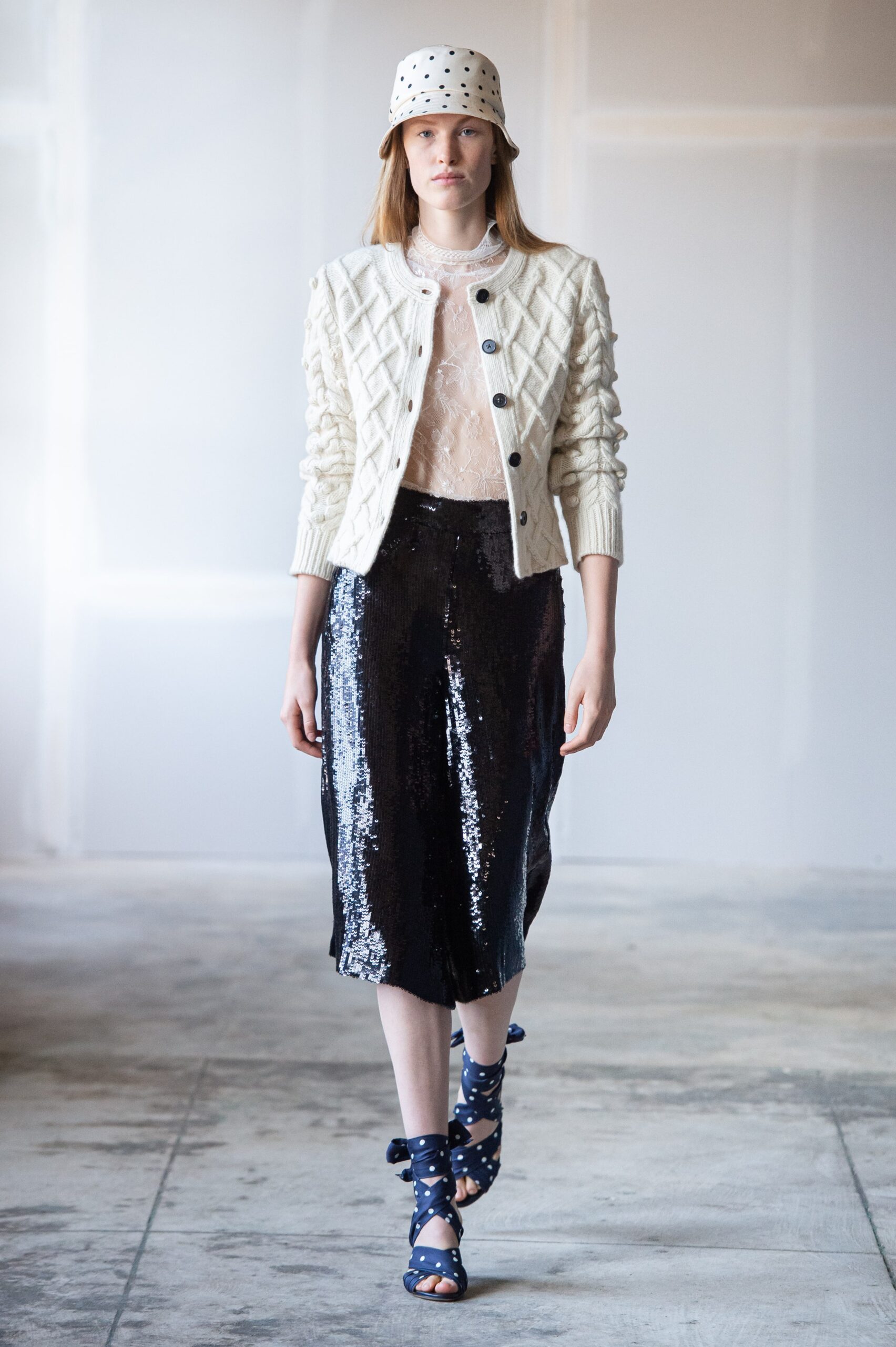 white knitted cardigan with black sequin skirt
