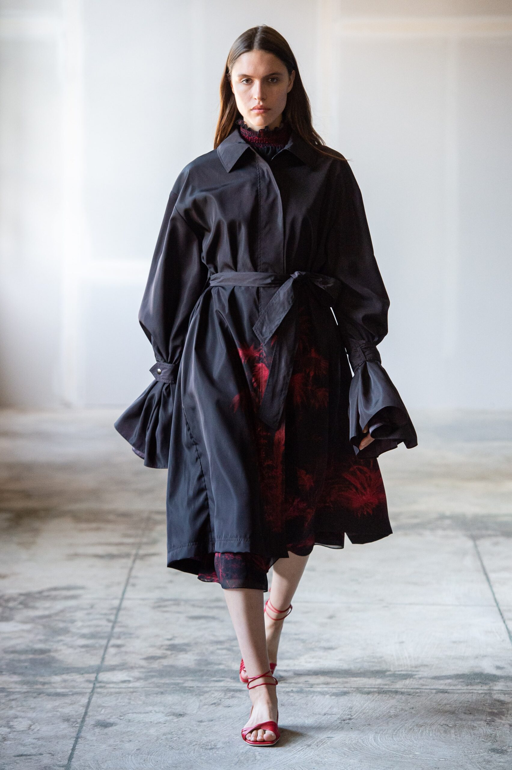 black coat and dress with red shoes