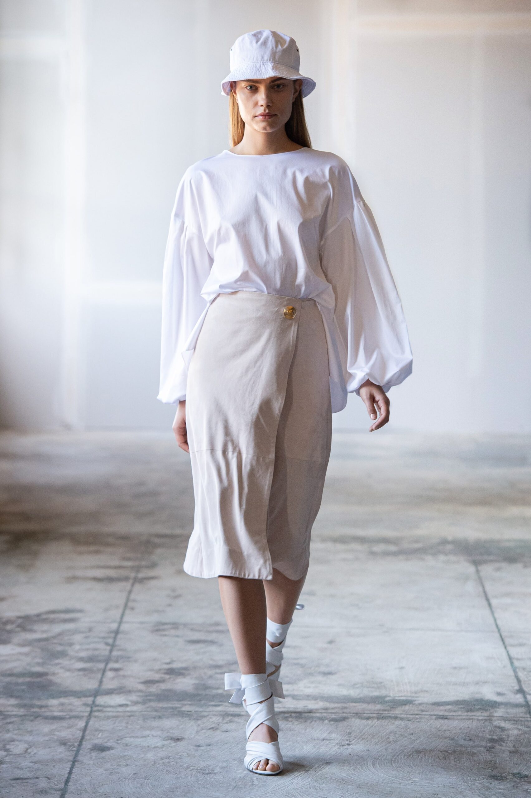 white relaxed top with beige pencil skirt