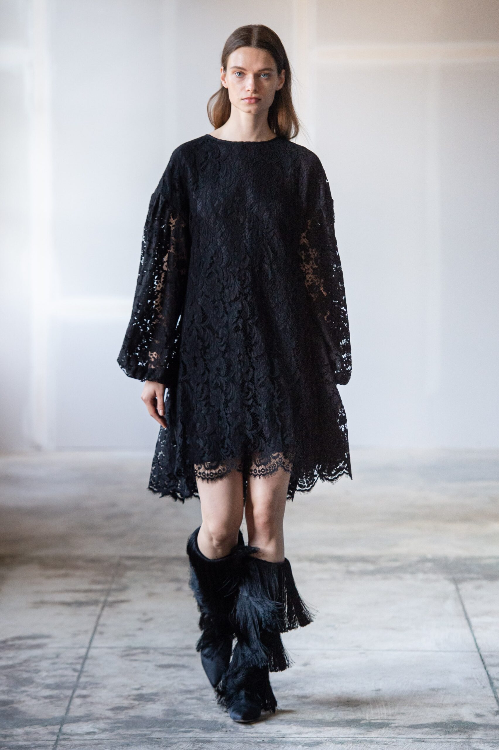 black lace mini dress with fringed boots