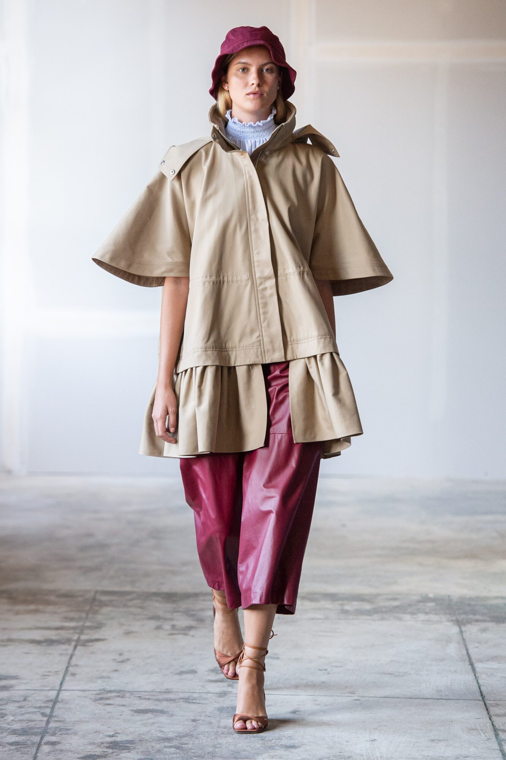 beige cape with red pants