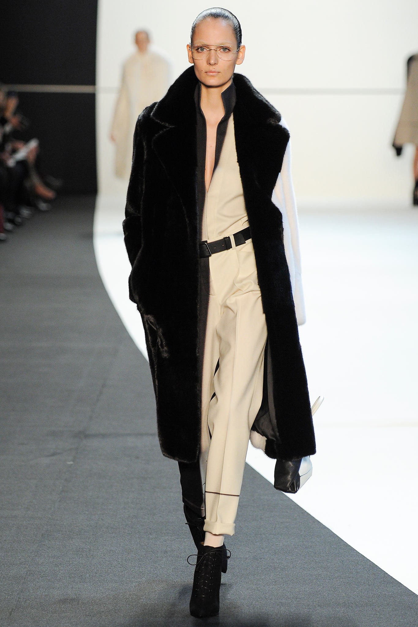 black faux-fur coat and beige jumpsuit