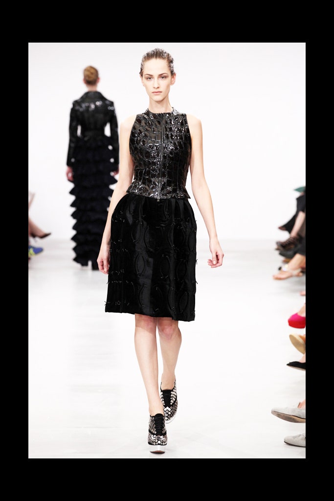 black pleated midi dress and leather jacket