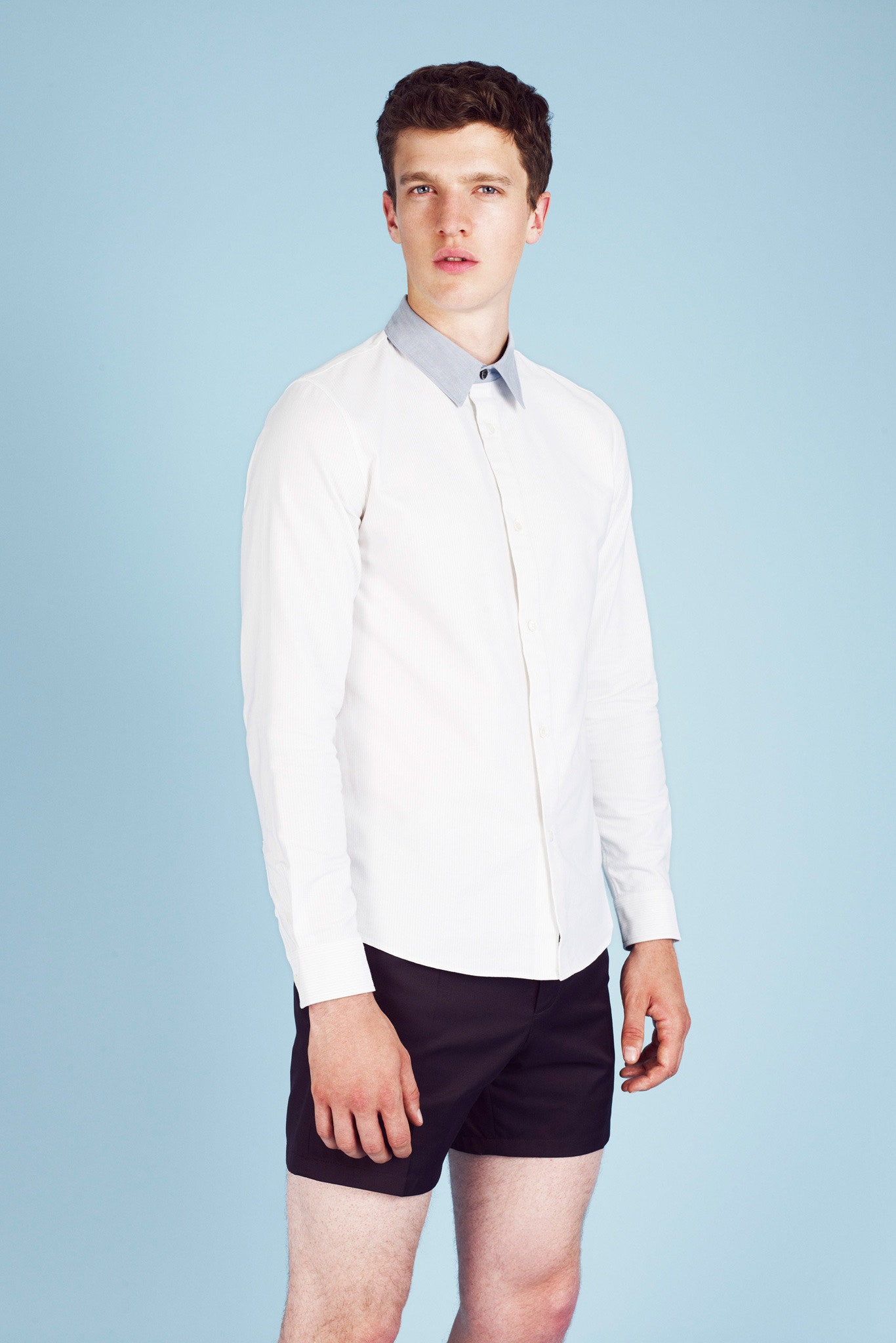 fitted white shirt and black shorts