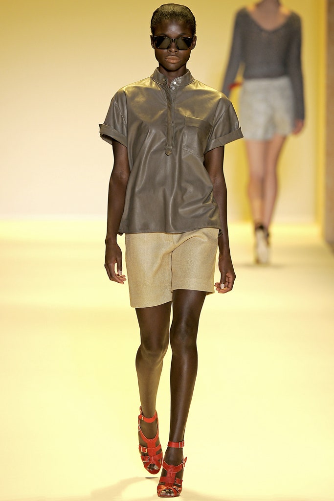 gray leather shirt and beige shorts