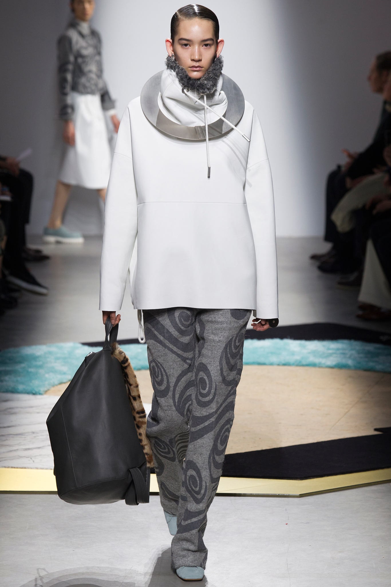 oversized white leather top with gray pants