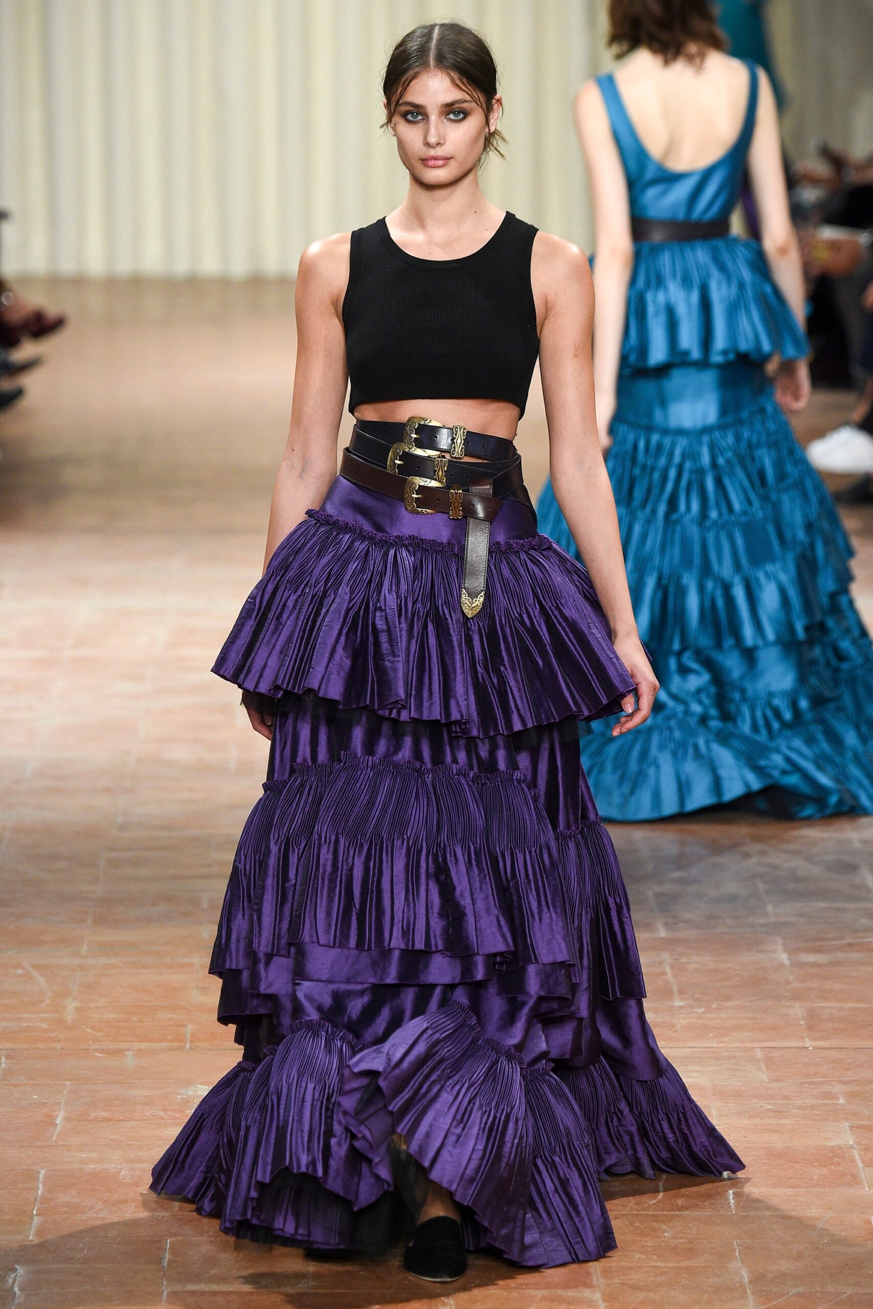 black fitted top with purple pleated skirt