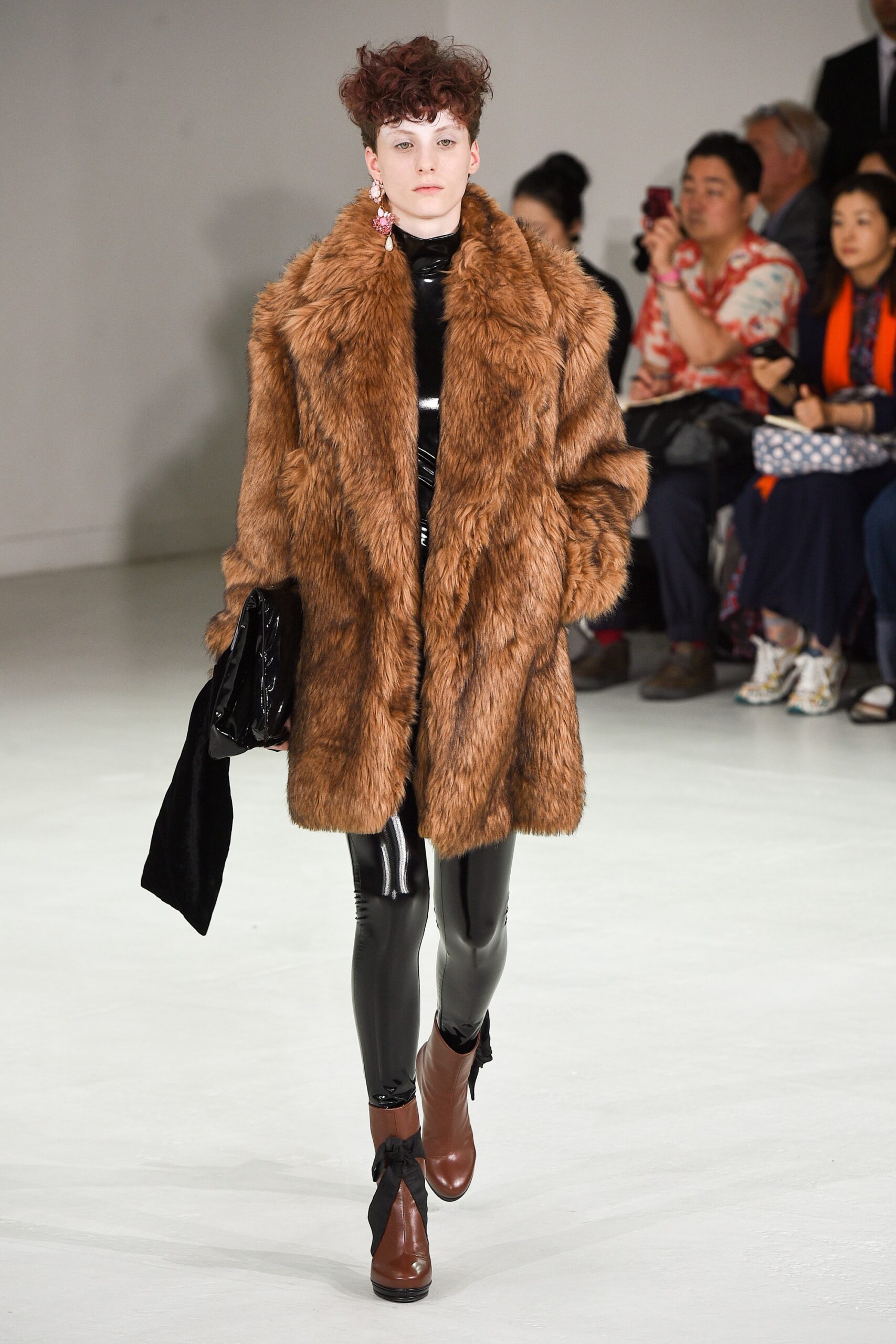 brown faux-fur coat with black vinyl pants