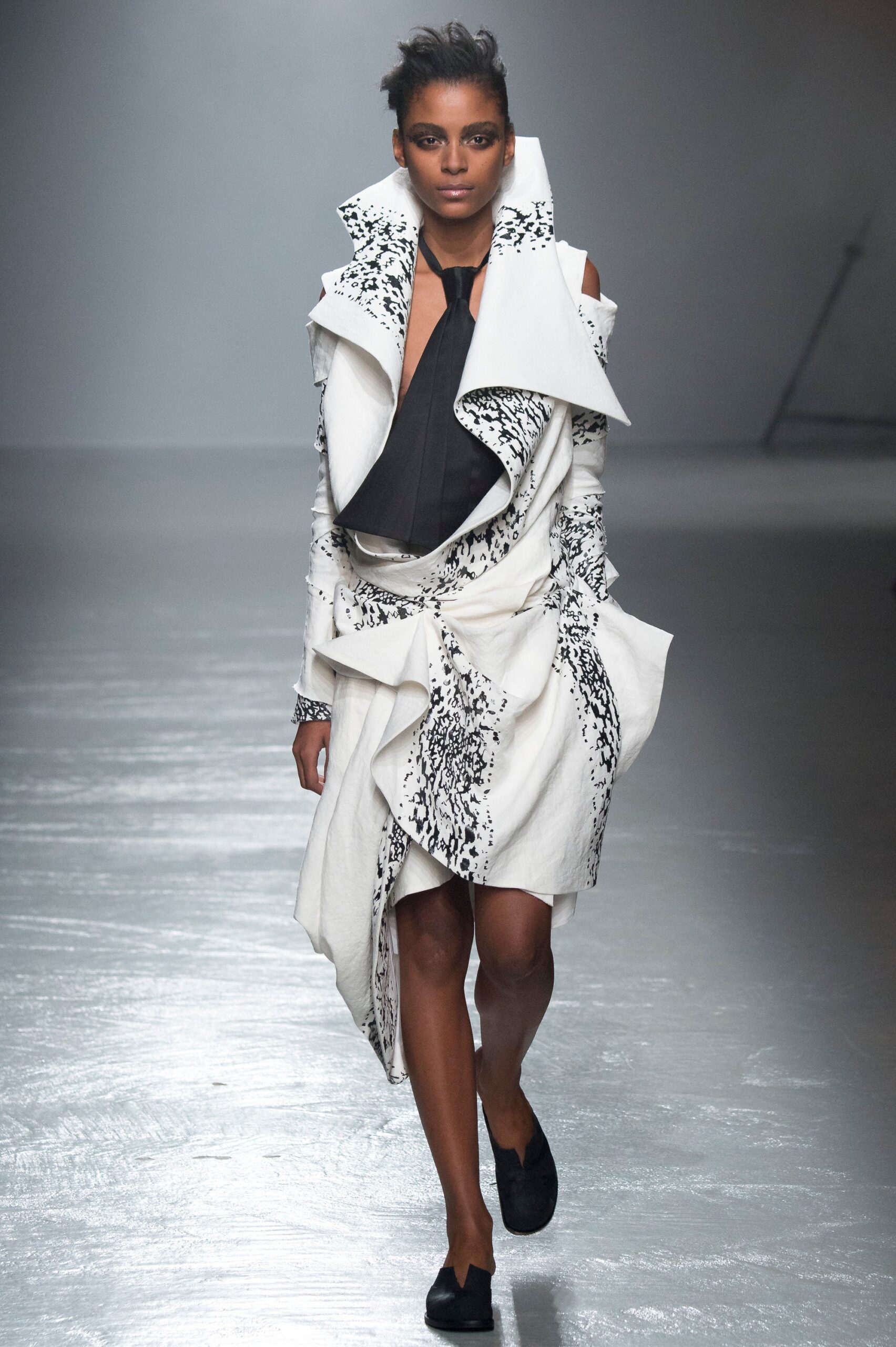 white and black draped coat