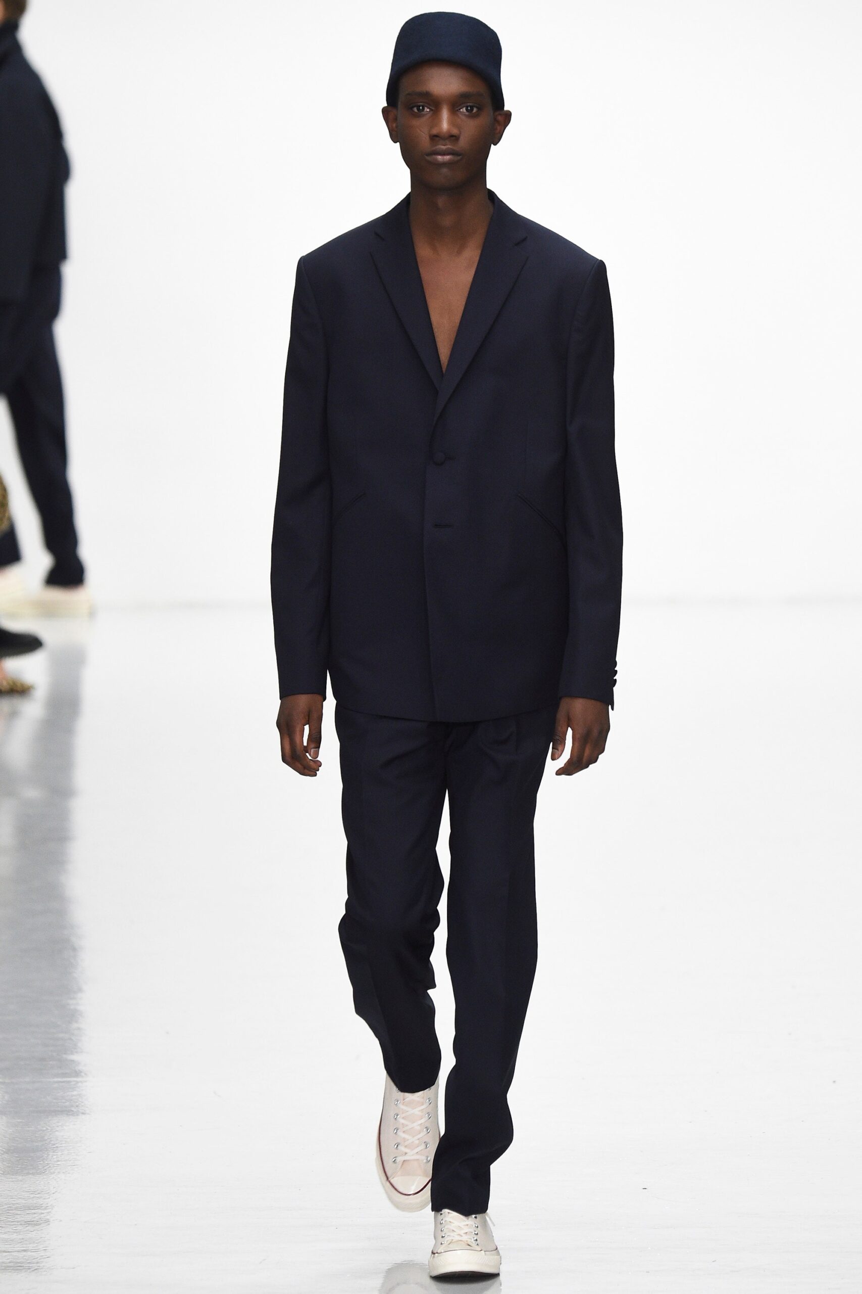 navy tailored suit with white shoes