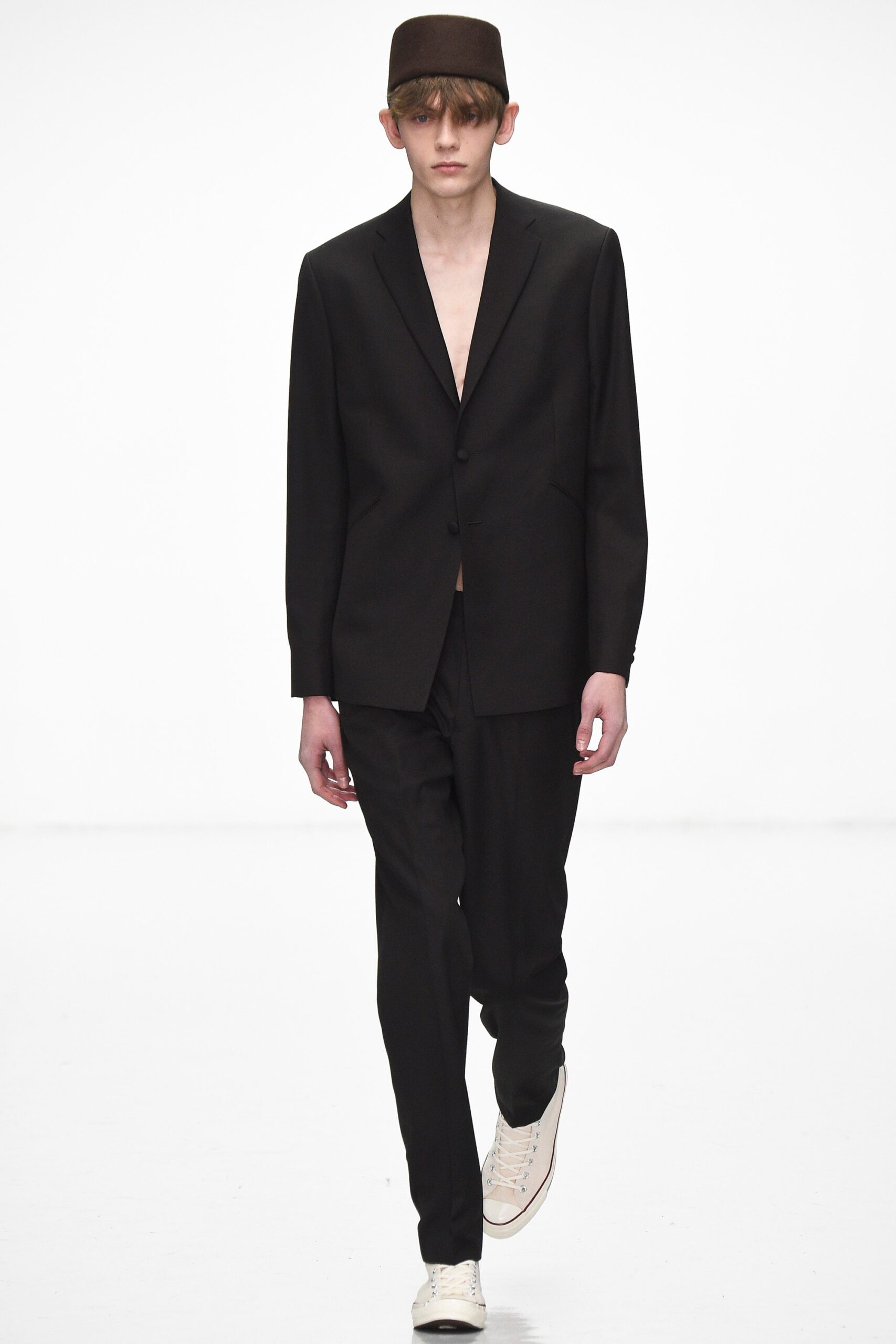 black tailored suit with white shoes