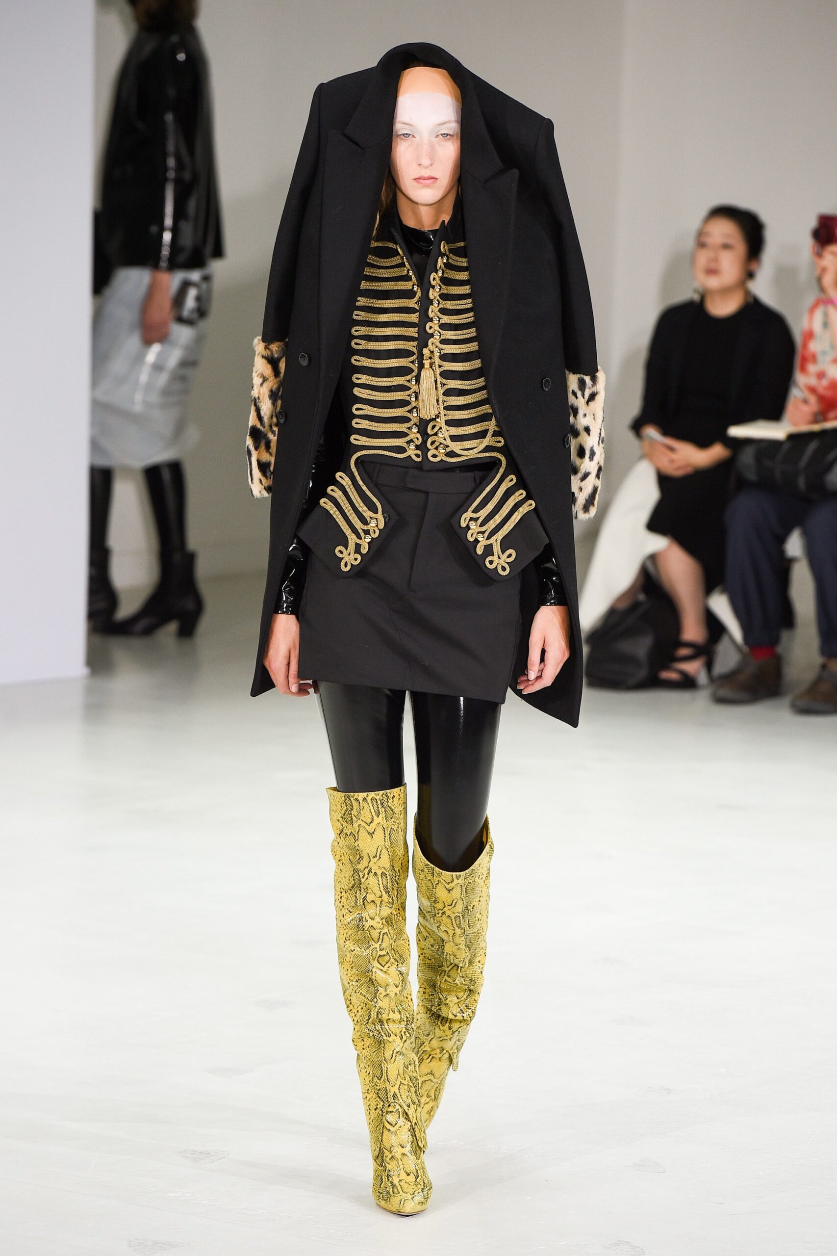 black oversized coat with yellow boots