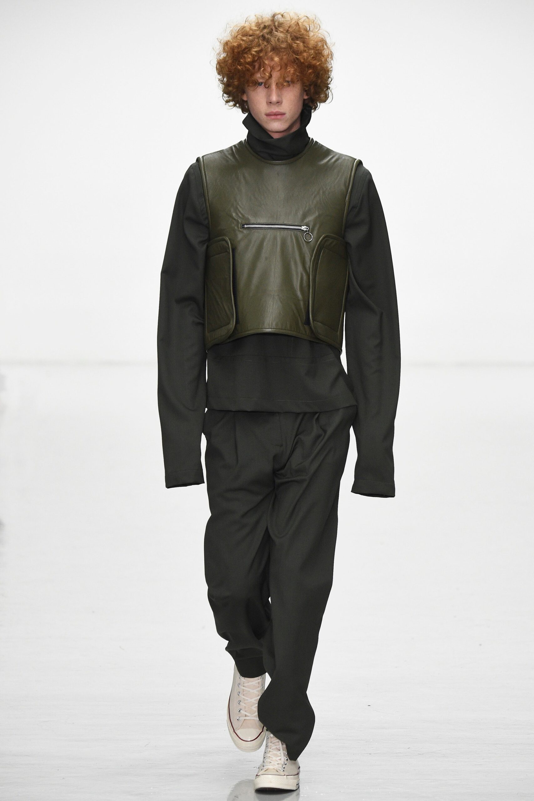 green leather fitted vest with black shirt and pants