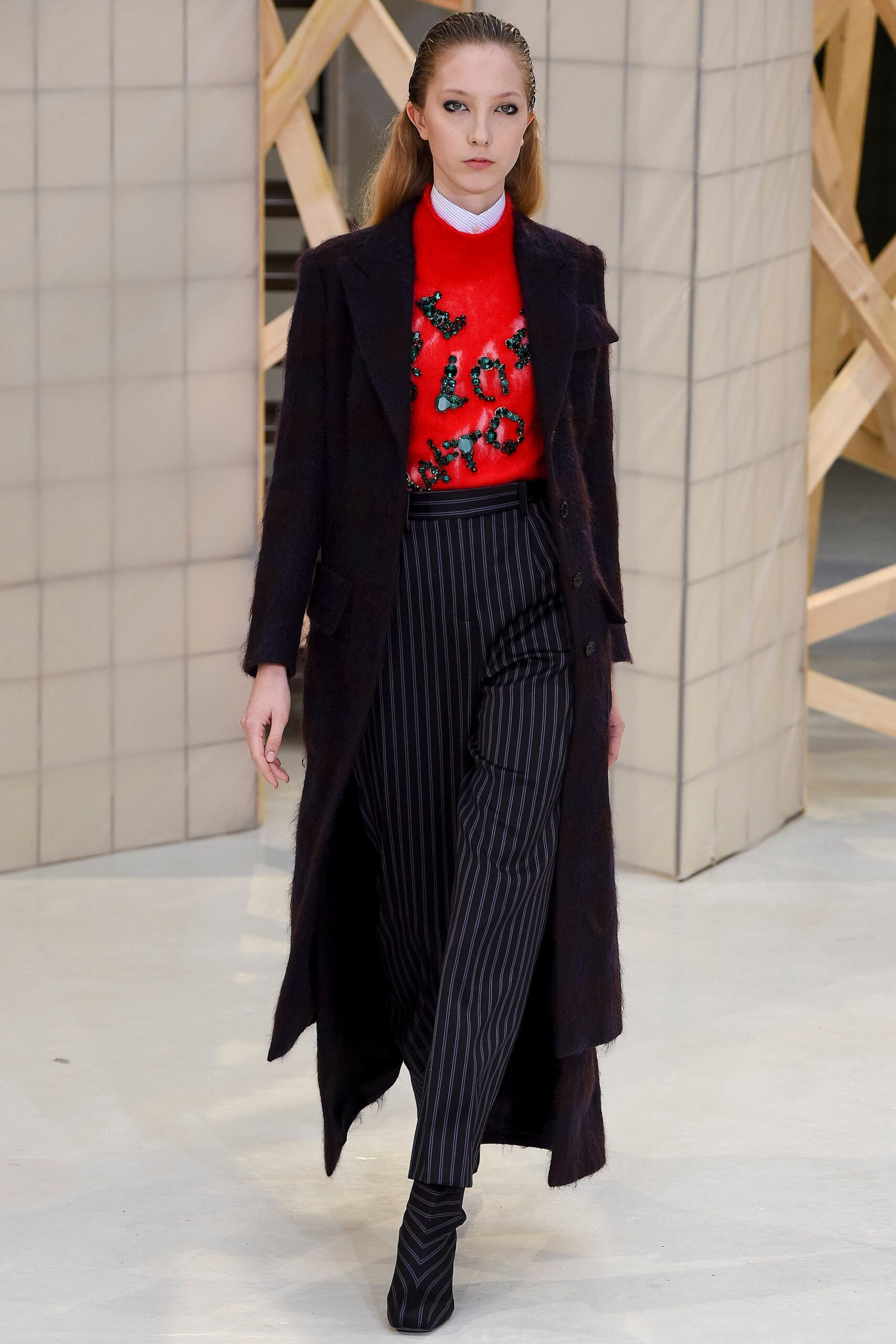 black wool coat red sweater striped pants