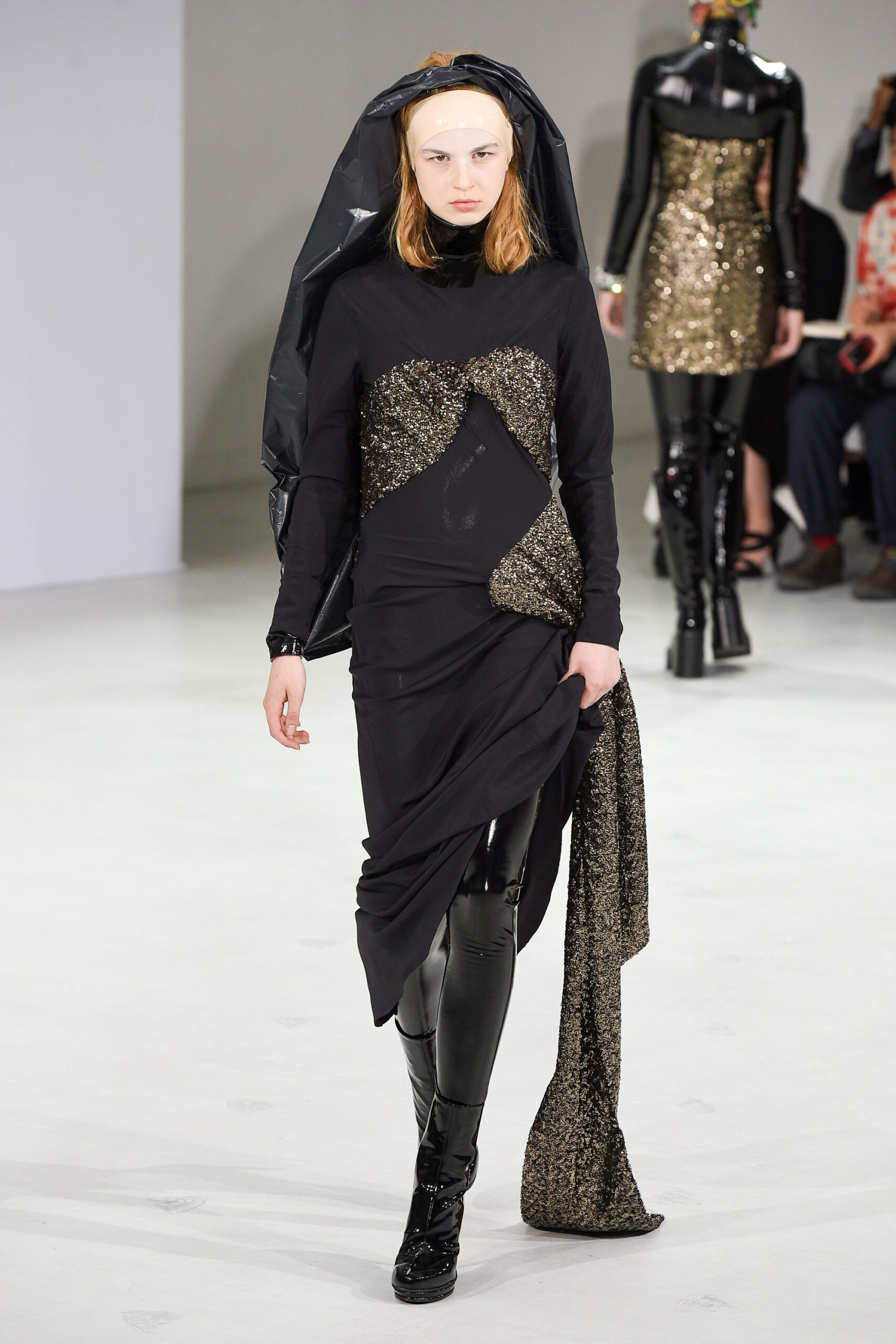 black and gold asymmetric dress with vinyl pants