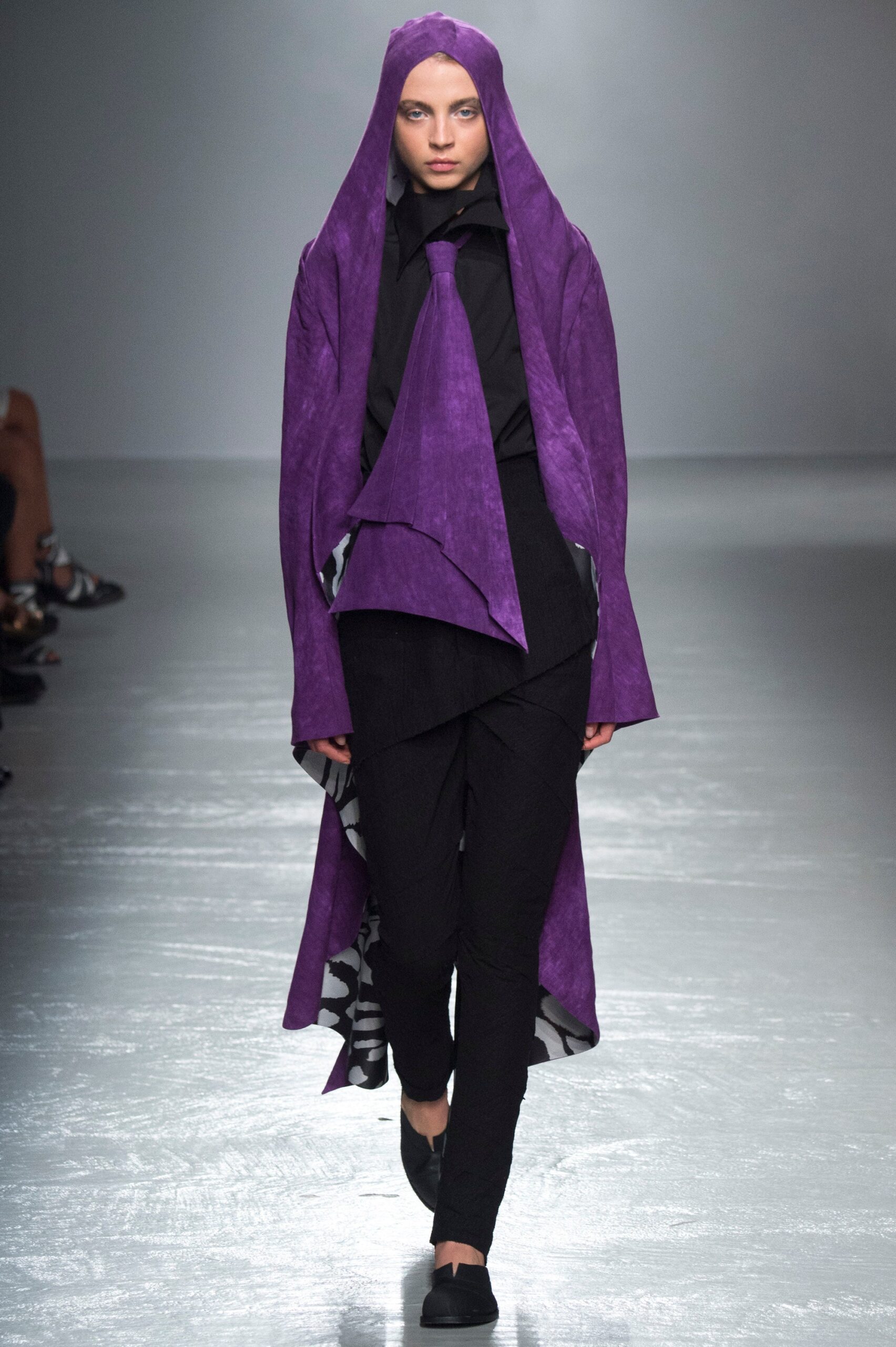 purple draped coat with black shirt