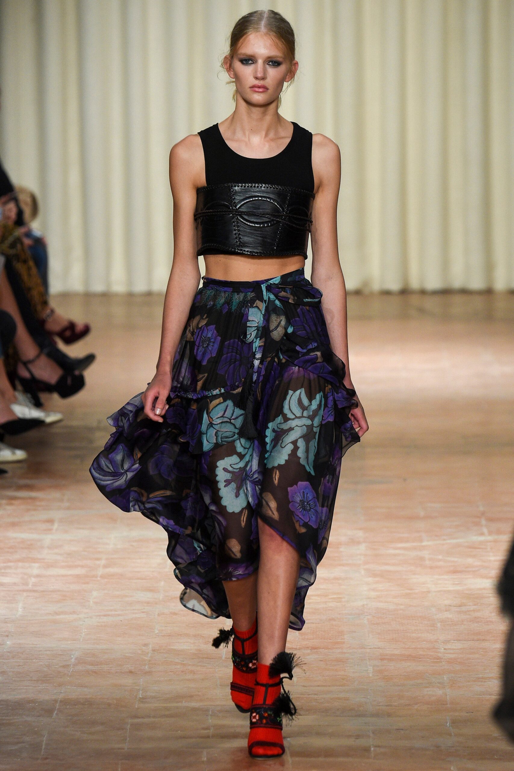 black leather cropped top and purple skirt