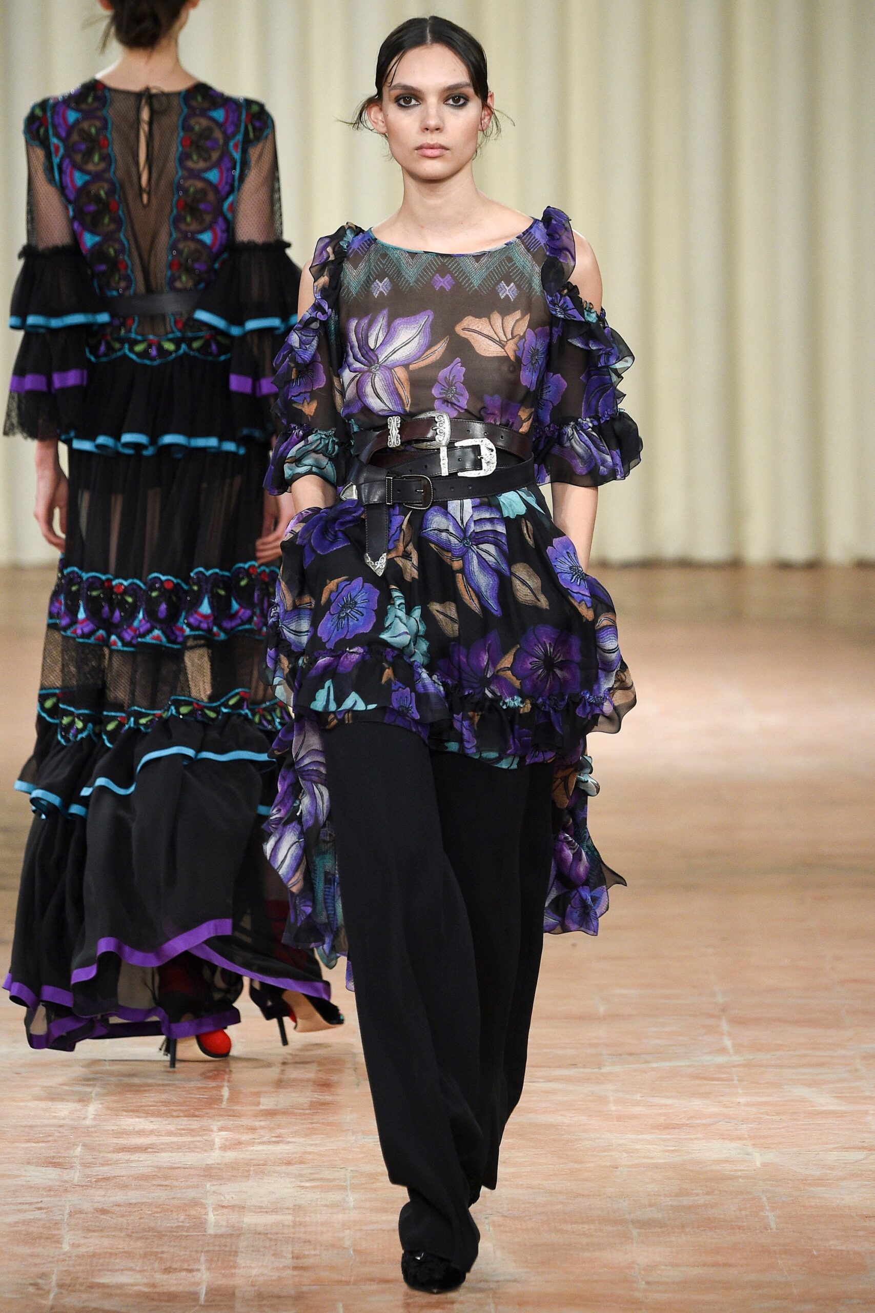 purple ruffled top with black pants