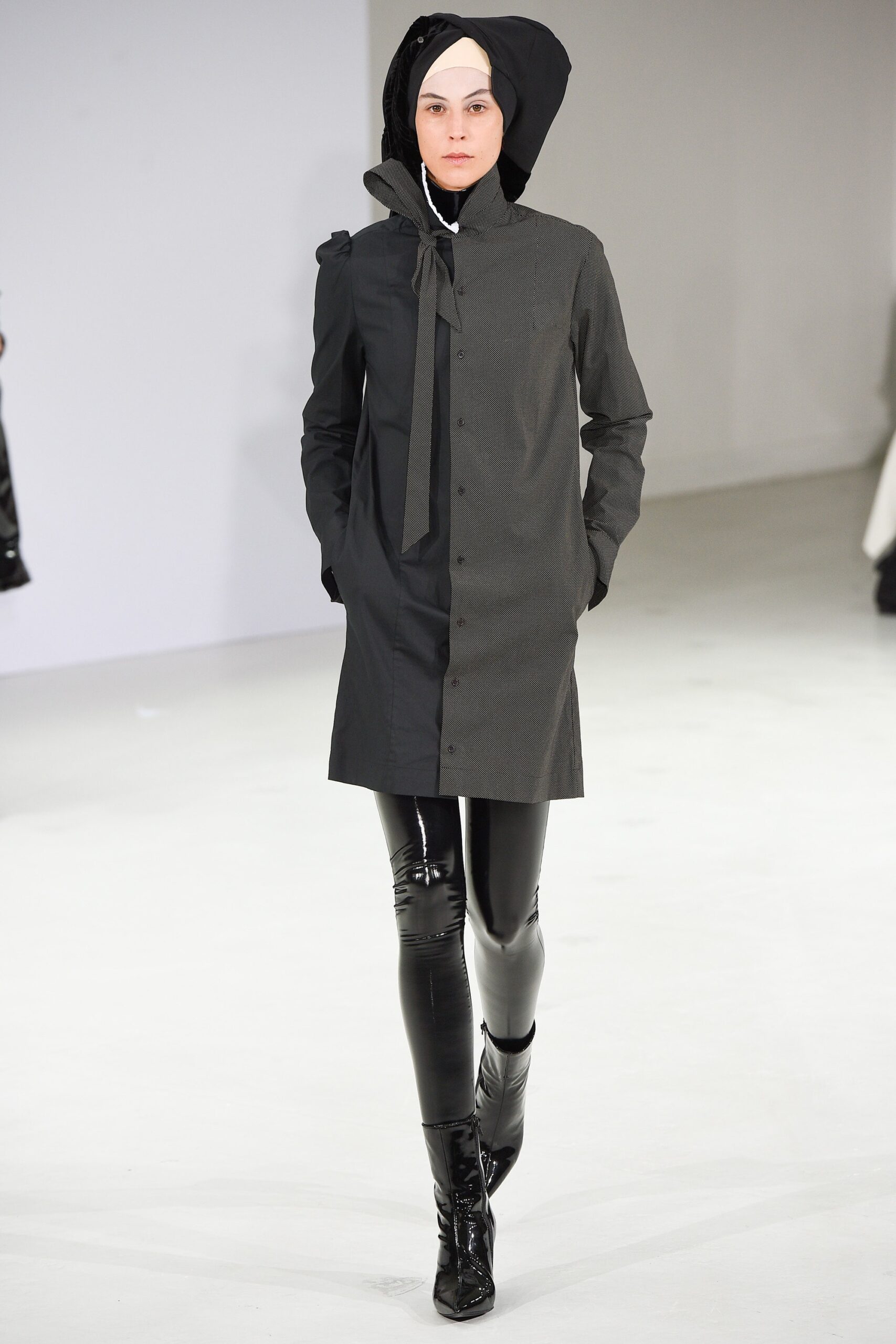 black gray fitted coat with vinyl pants