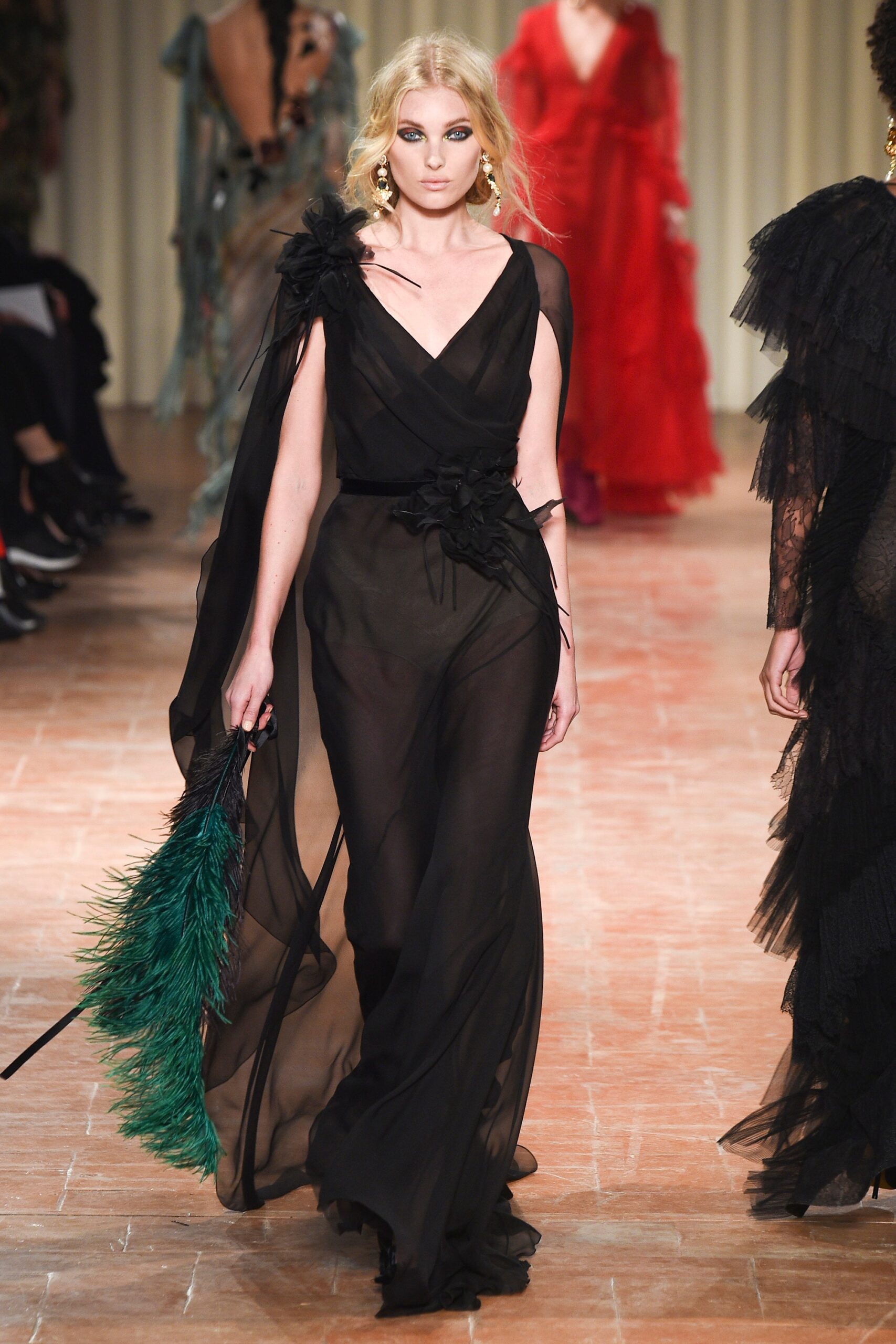 black chiffon gown with feather accessory