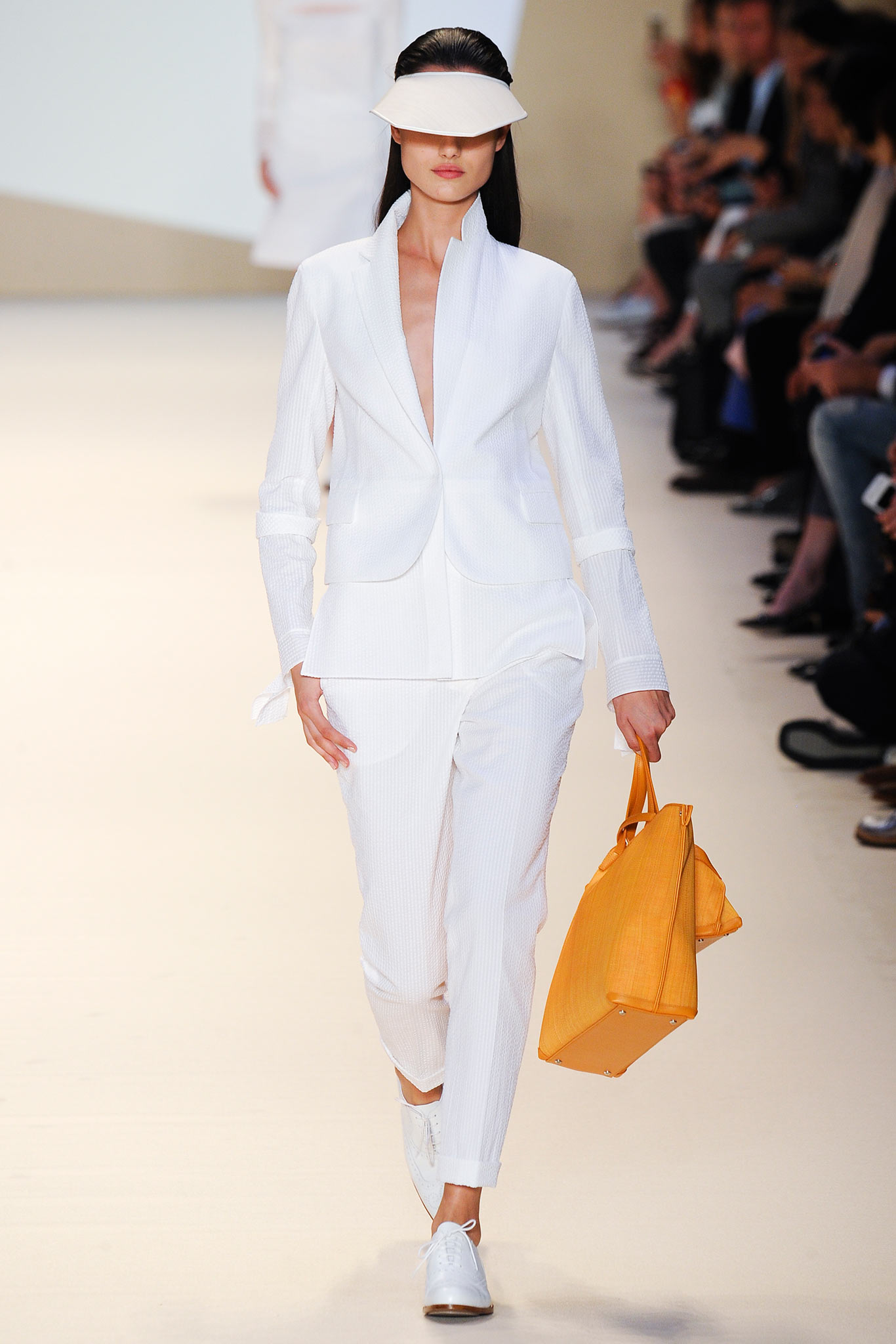 white tailored suit with orange bag