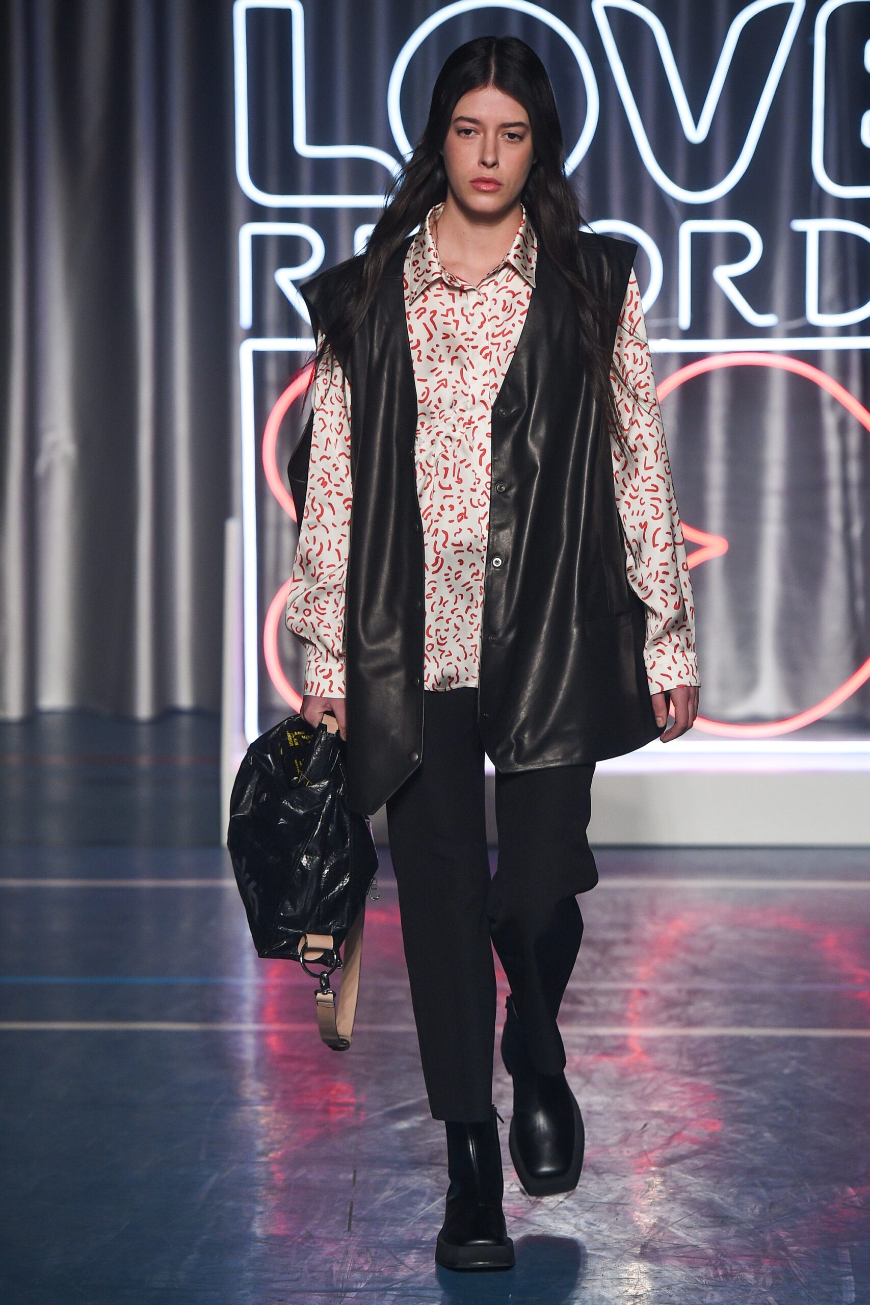 black leather vest with printed shirt