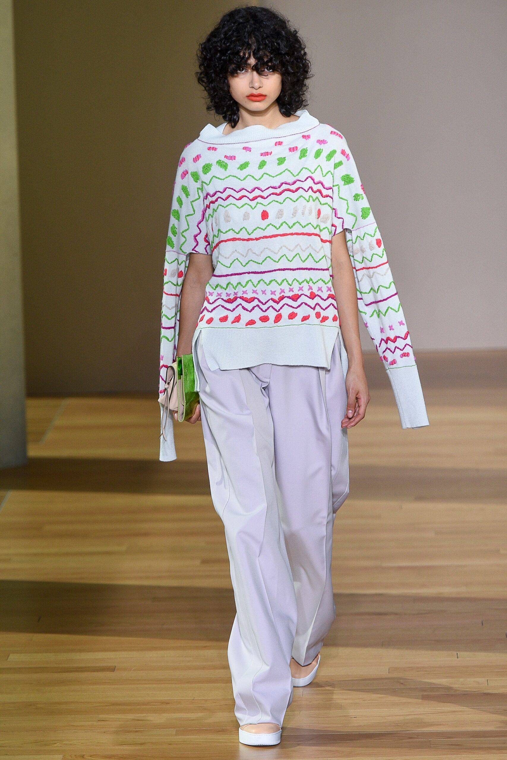 embroidered white relaxed sweater and gray pants