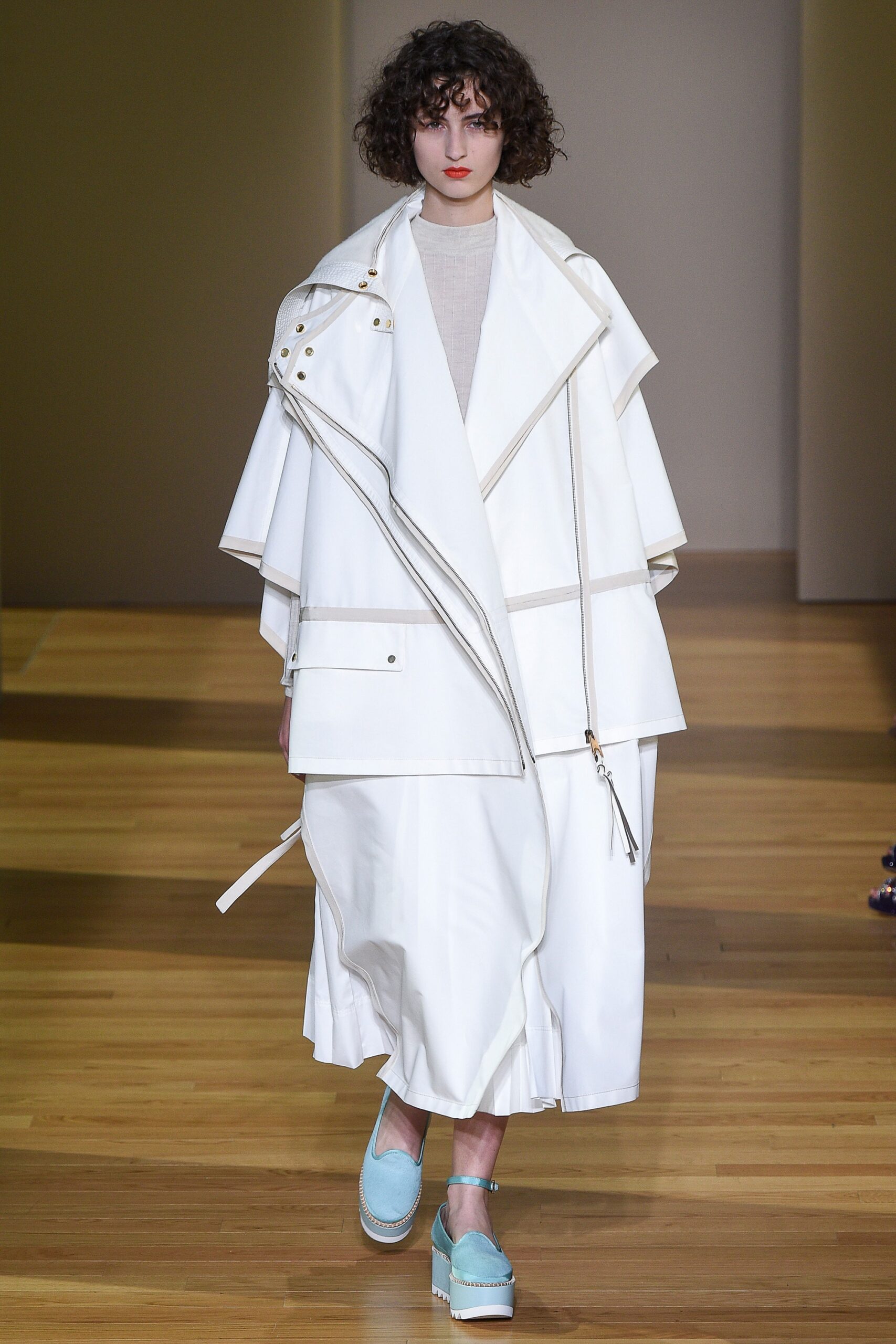 oversized white vinyl coat with fitted beige dress