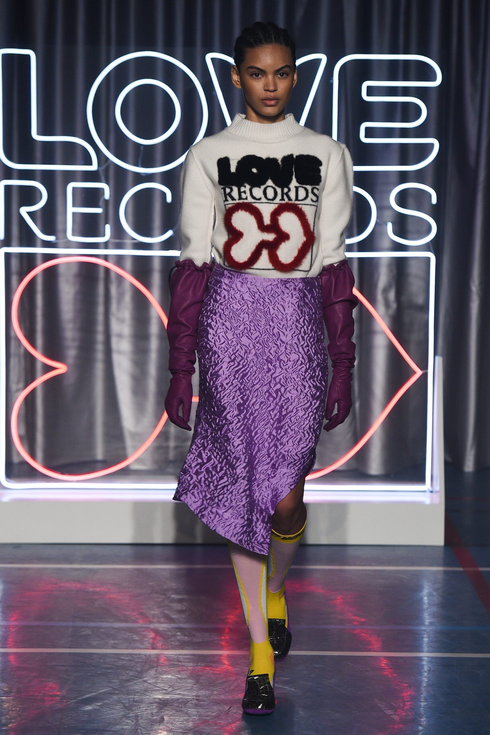 white printed sweater and purple skirt