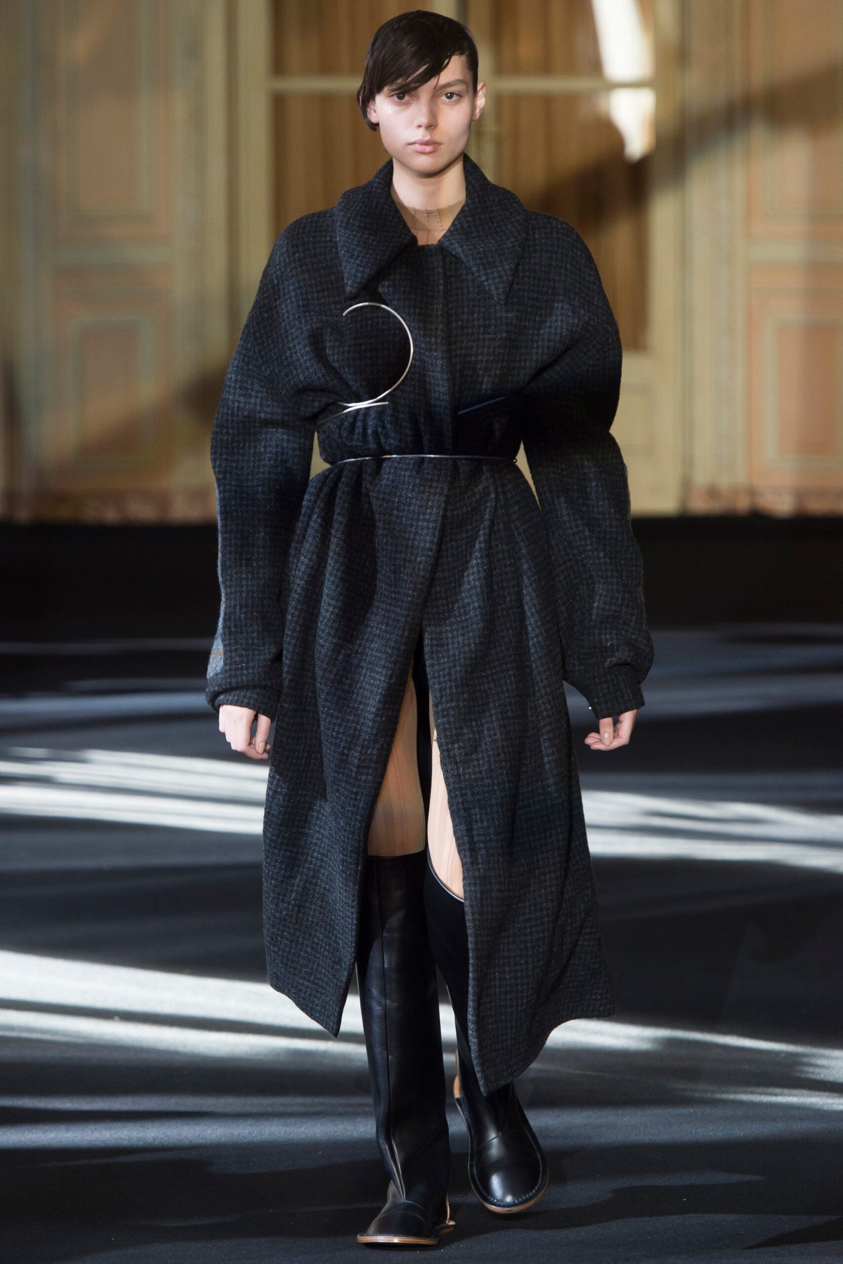 oversized black wool coat and fitted boots