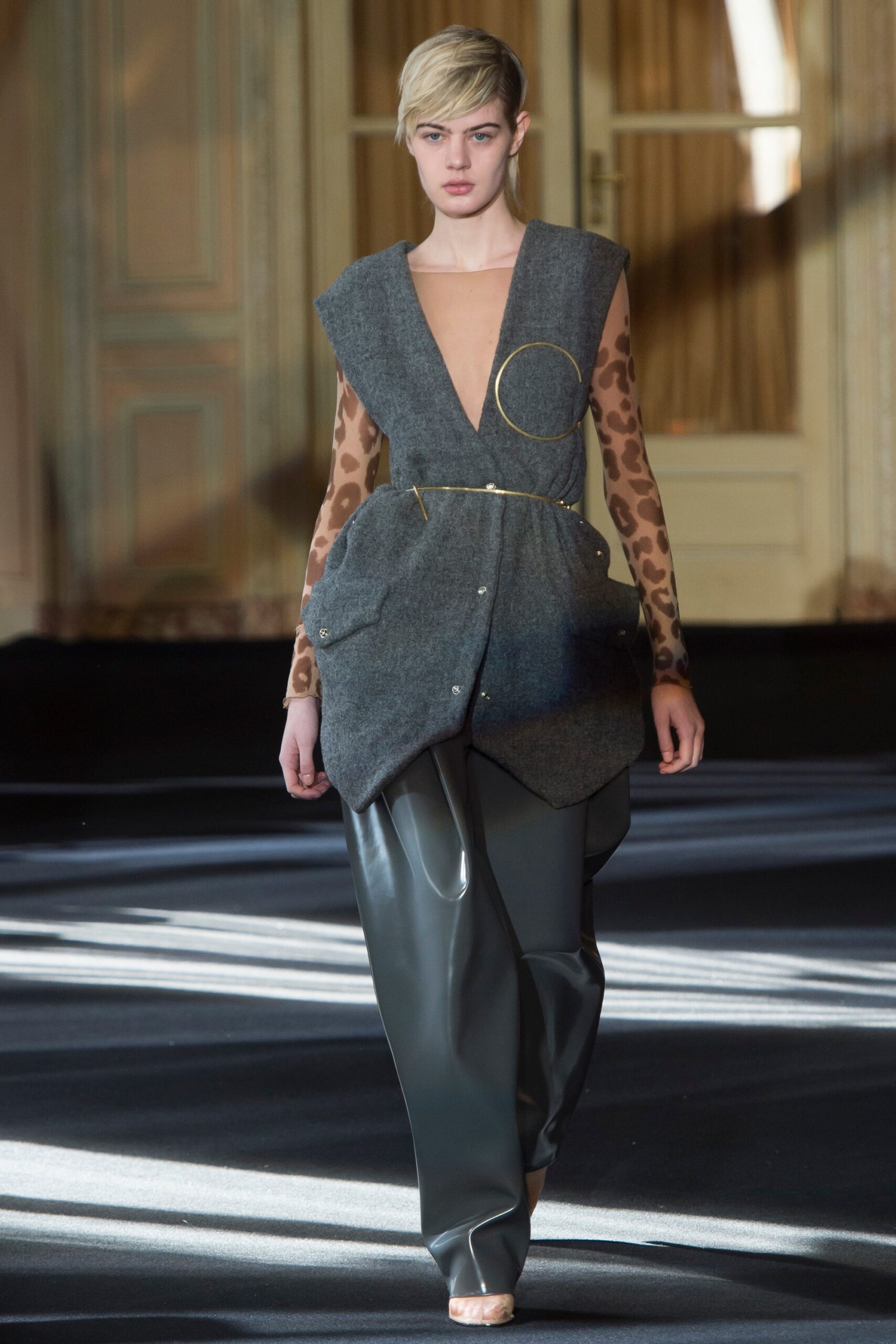 gray wool sleeveless top and black vinyl pants