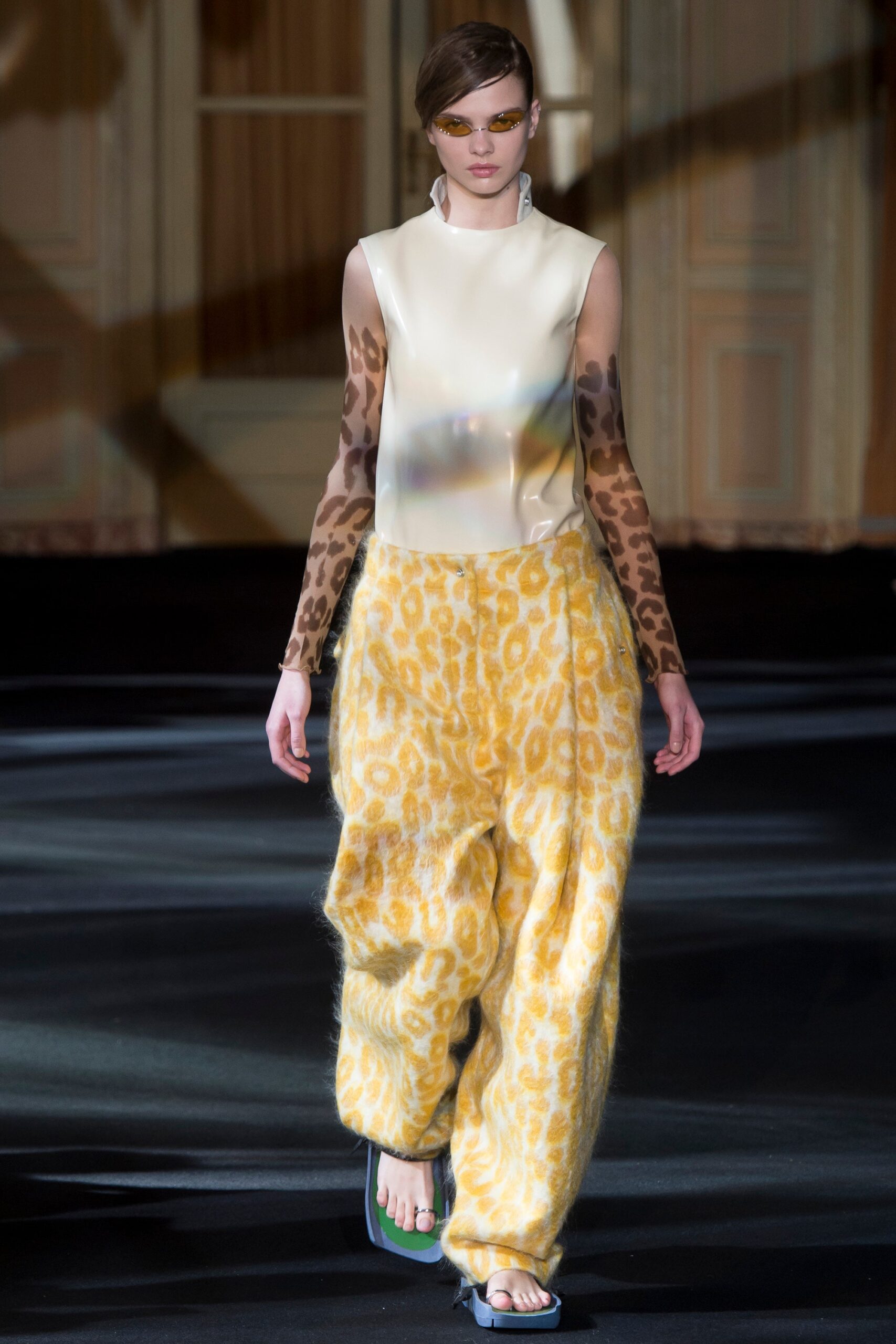 white sheer sleeveless top and yellow flared pants