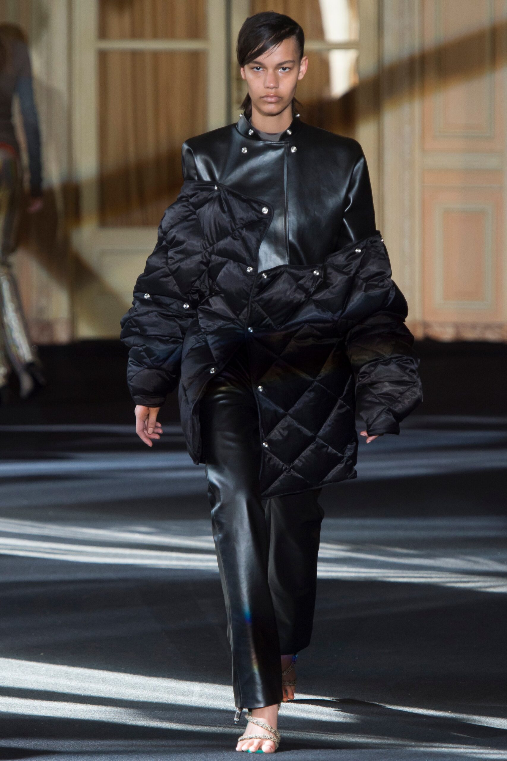black leather oversized jacket and fitted pants