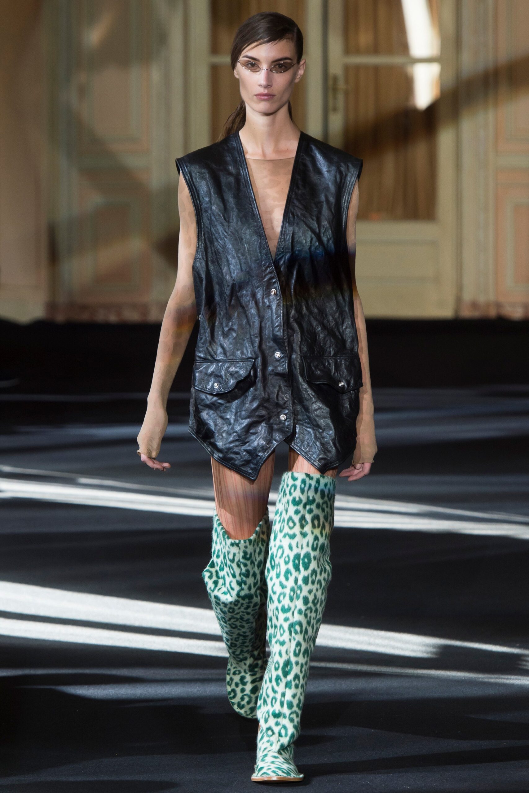 black leather vest with animal-print boots