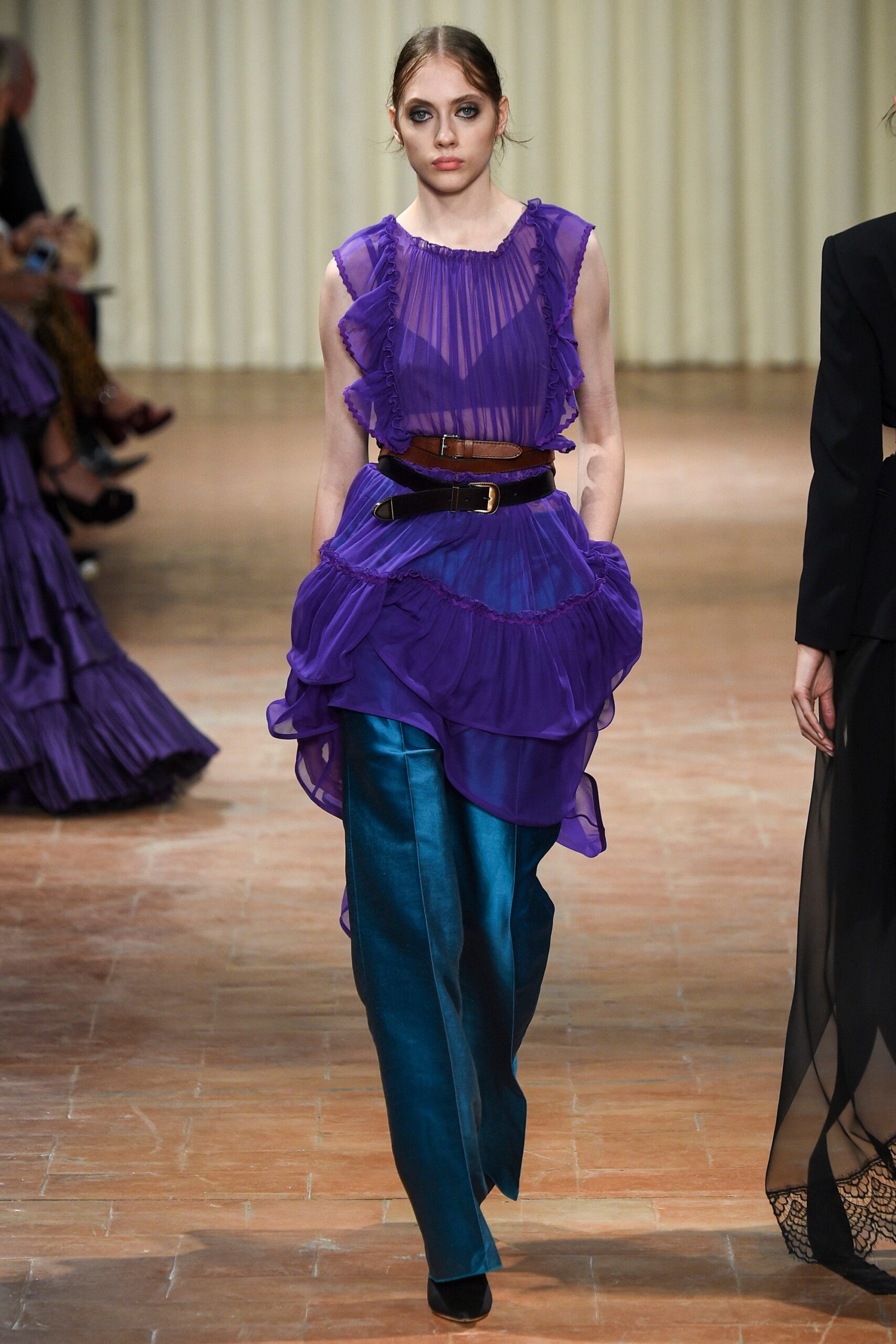 purple ruffled top with teal pants