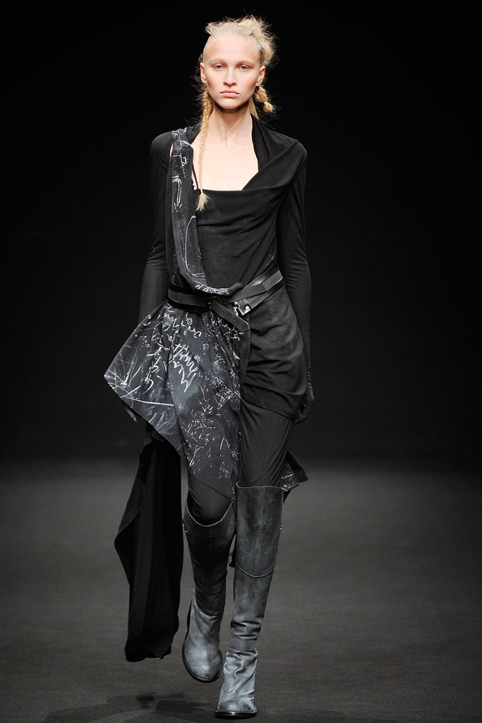 black fitted asymmetric dress with knee-high boots