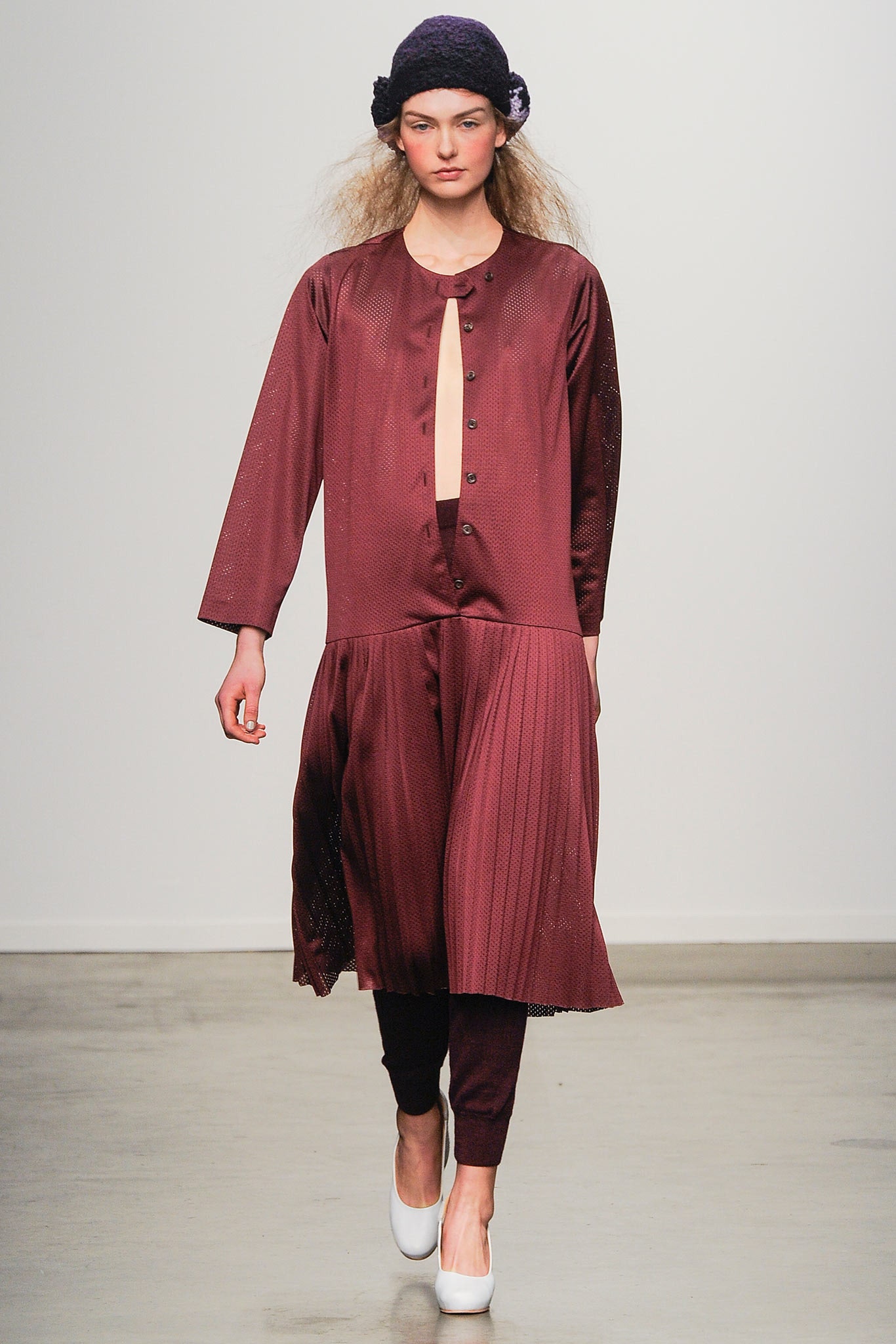 A relaxed burgundy silk dress with long sleeves, a V-neckline, and pleated detailing.