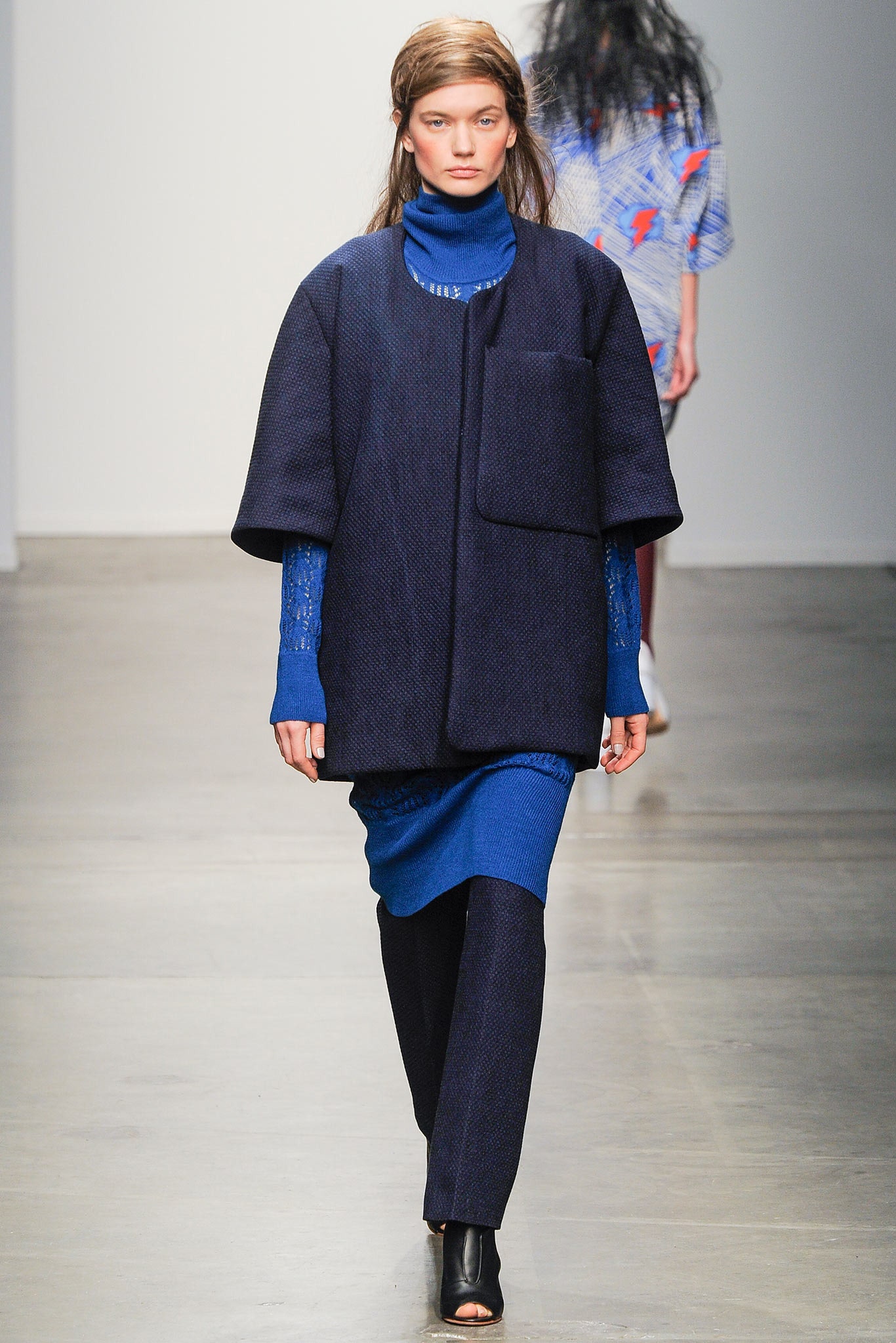 A relaxed blue cotton jacket with long sleeves paired with matching pants, featuring a layered design.