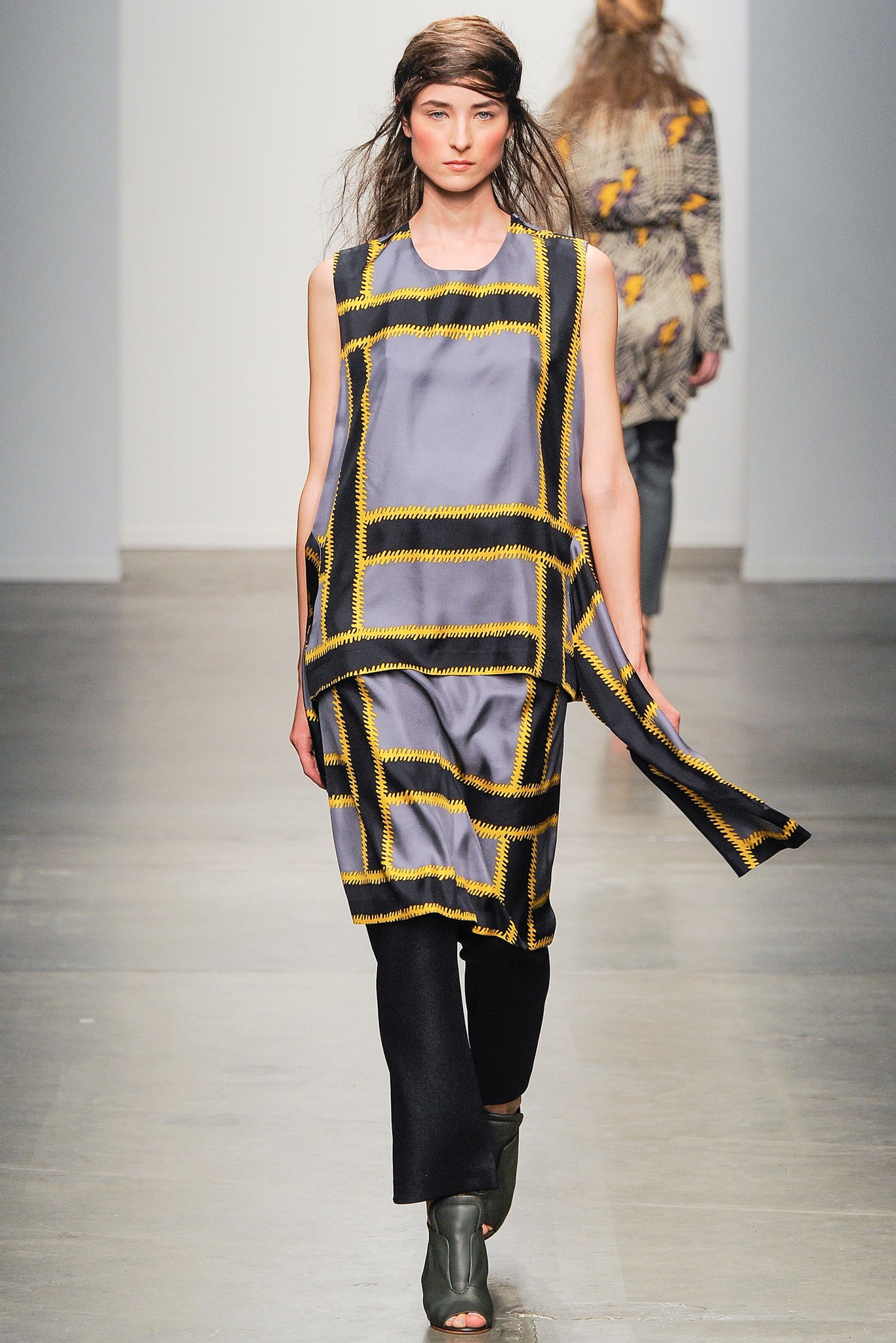 A relaxed gray silk sleeveless dress with a high neckline and asymmetric design.
