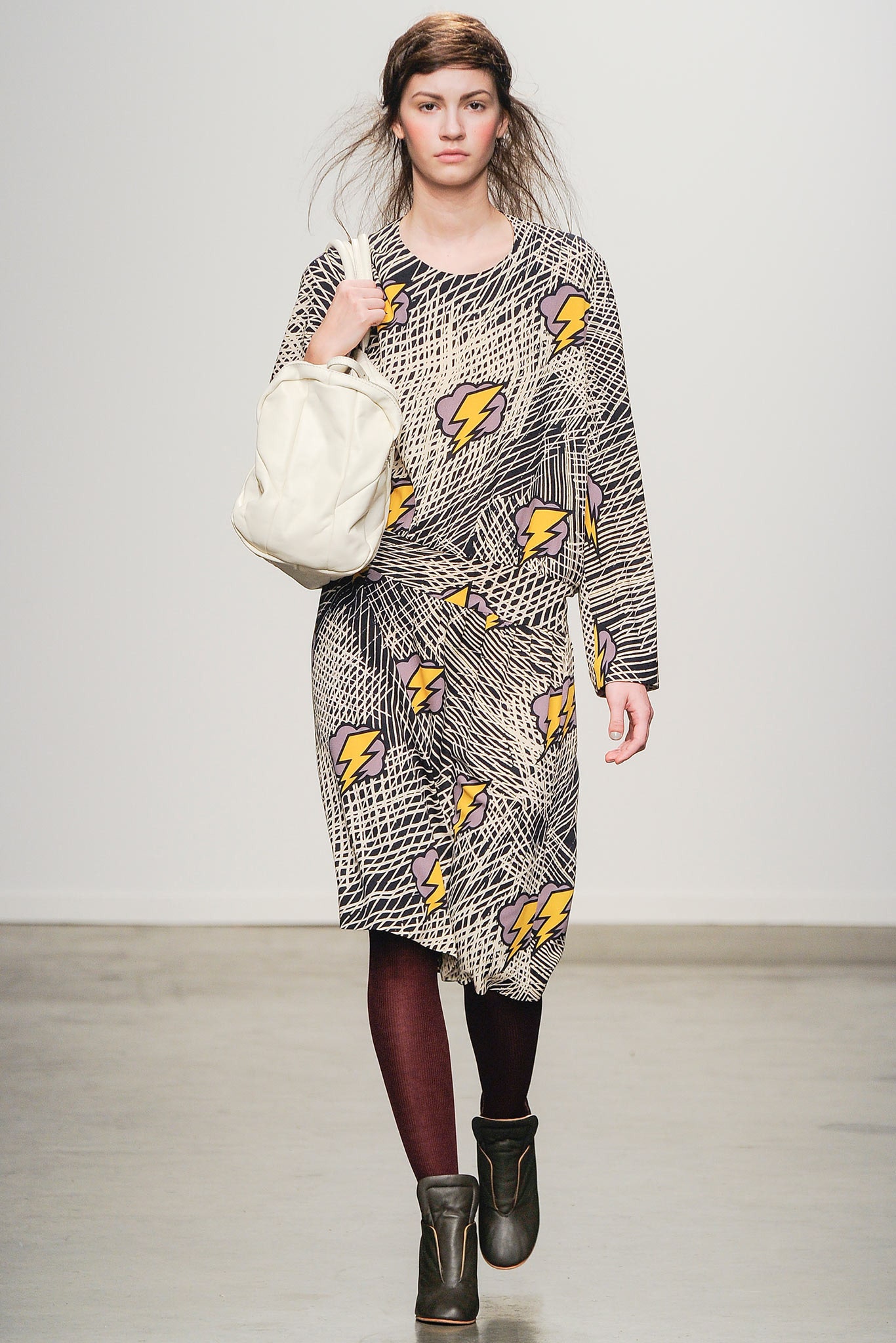 A relaxed multicolor dress with long sleeves and a collared neckline featuring a bold print.