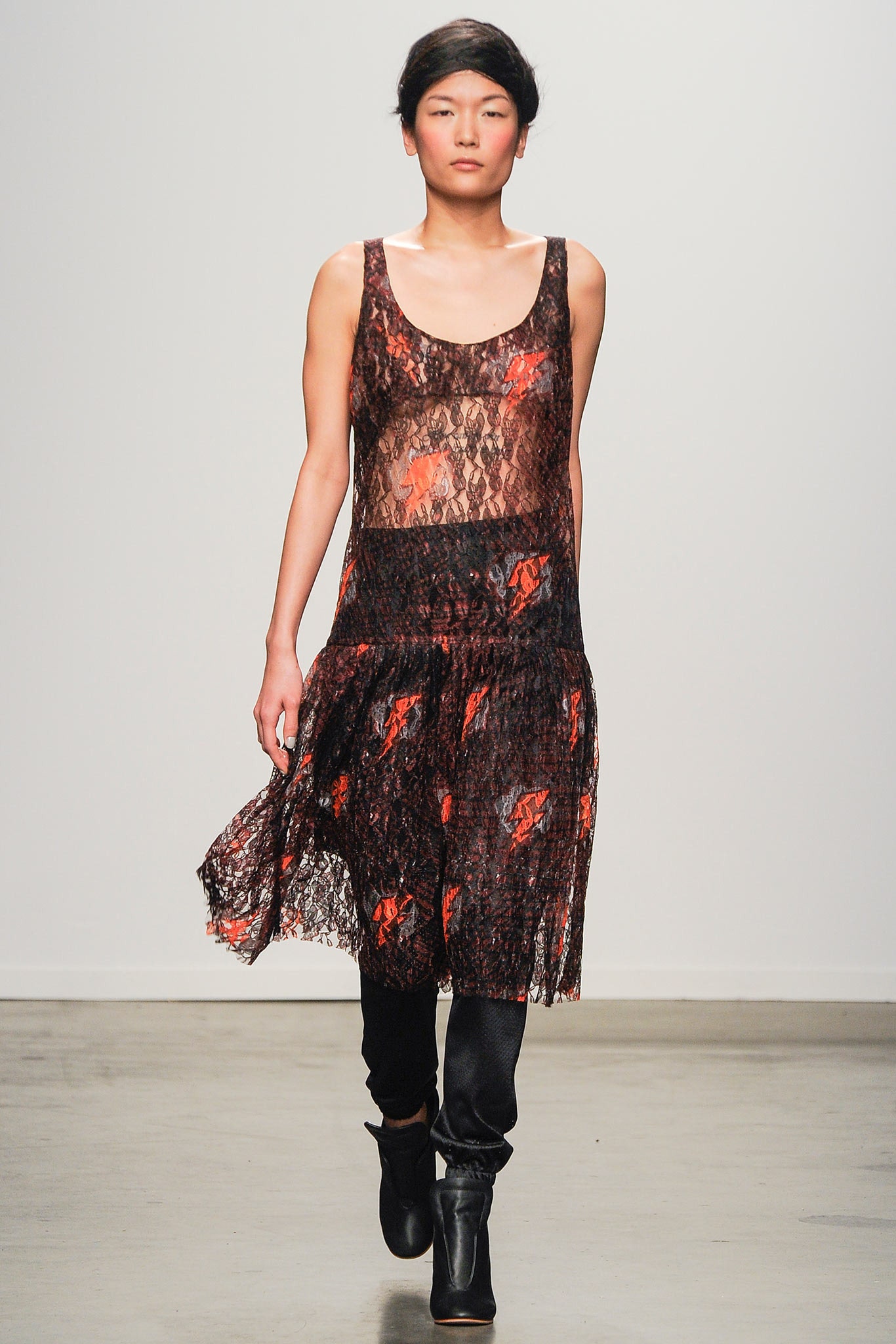 A relaxed black lace sleeveless dress with a V-neckline and layered design featuring red accents.