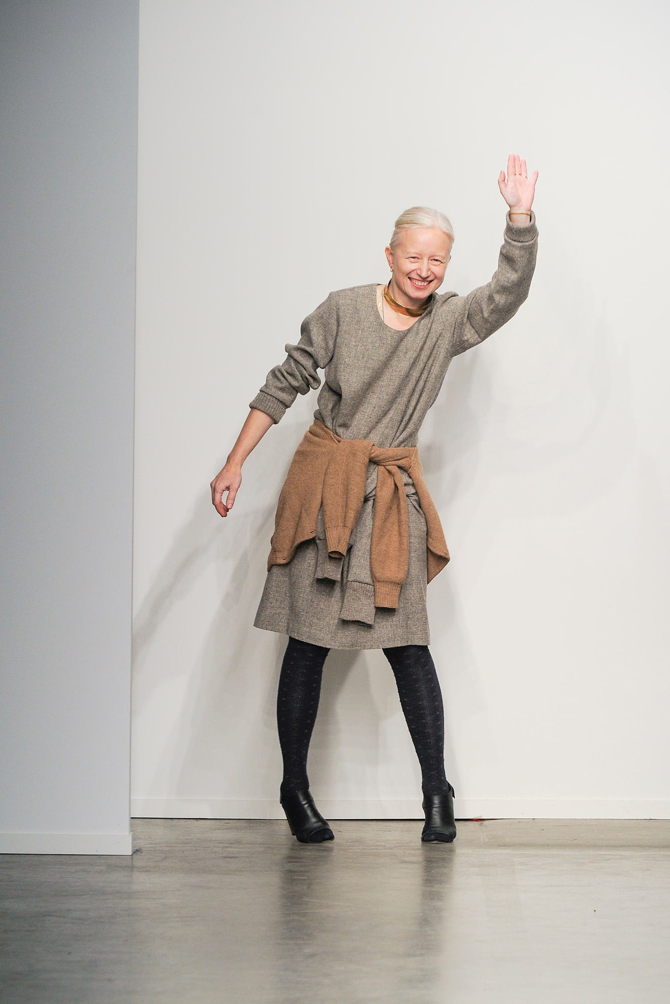 A relaxed gray wool dress with long sleeves, a V-neckline, and a belted detail.