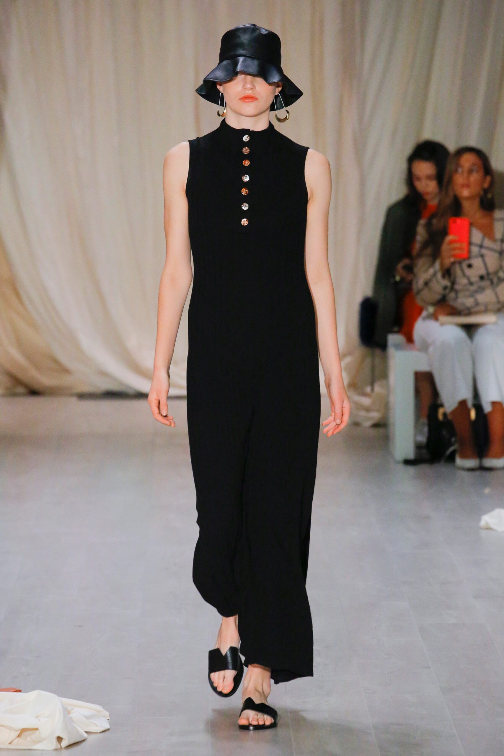 black fitted jumpsuit with bucket hat
