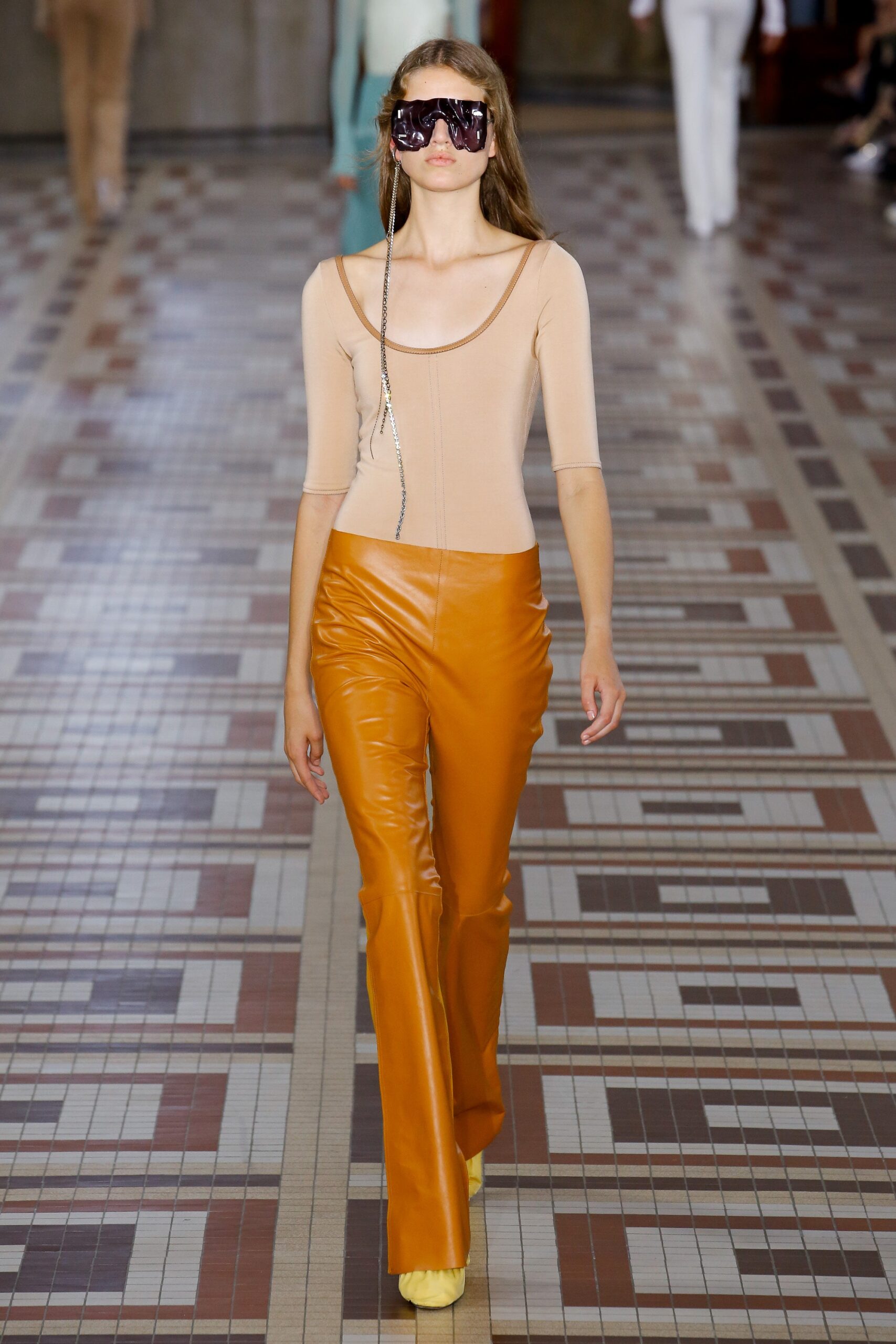 beige fitted top and orange flared pants